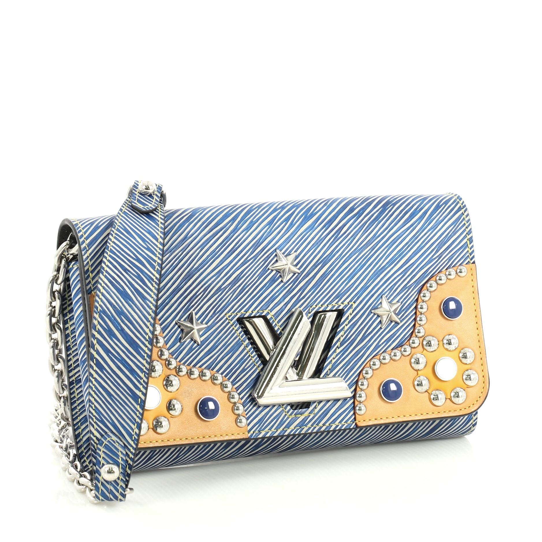This Louis Vuitton Twist Chain Wallet Studded Epi Leather, crafted from blue epi leather, features chain link strap, stud detailing and silver-tone hardware. Its flap with twist lock closure opens to a black leather interior with zip pocket and
