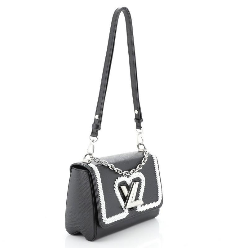 This Louis Vuitton Twist Convertible Handbag Whipstitch Epi Leather MM, crafted from black whipstitch epi leather, features chain link strap with leather pad, frontal flap, and silver-tone hardware. Its LV twist lock closure opens to a black