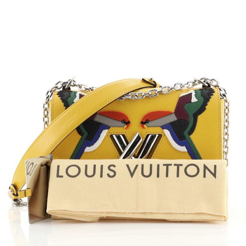 This Louis Vuitton Twist Handbag Bird Motif Epi Leather MM, crafted from yellow epi leather, features chain link strap with leather pad, frontal flap with bird motif pattern, and silver-tone hardware. Its LV twist lock closure opens to a yellow