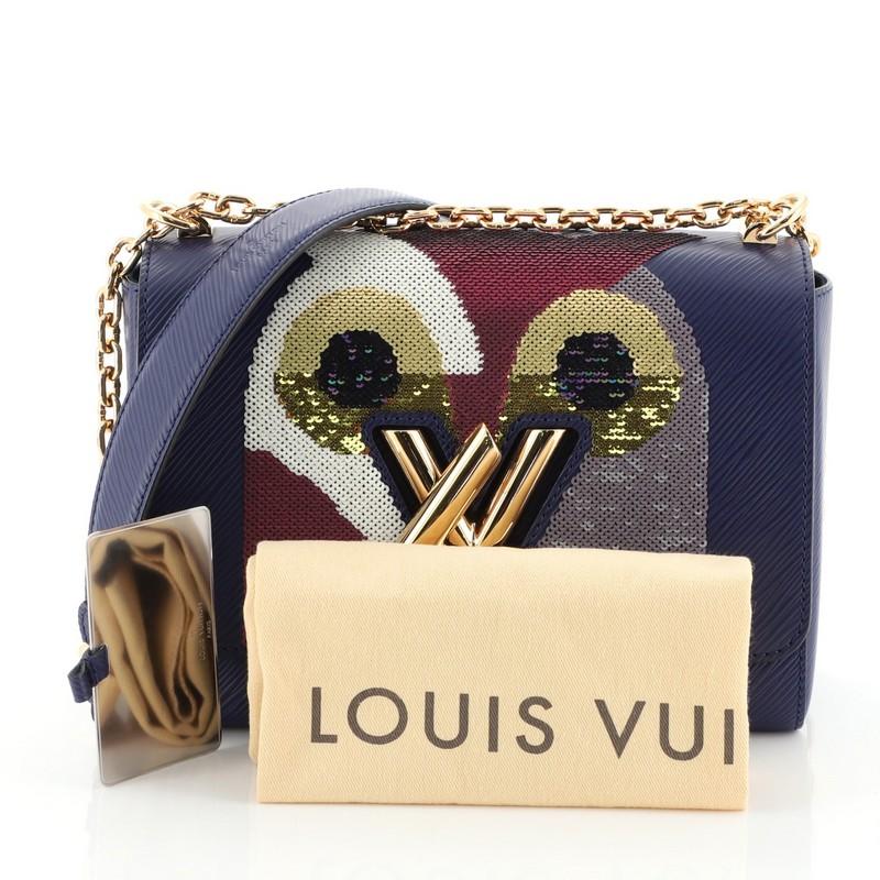 This Louis Vuitton Twist Handbag Bird Motif Epi Leather MM, crafted from blue epi leather, features chain link strap with leather pad, frontal flap with bird motif pattern, and gold-tone hardware. Its LV twist lock closure opens to a blue microfiber