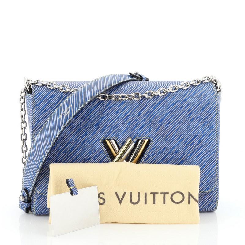 This Louis Vuitton Twist Handbag Epi Leather MM, crafted from blue epi leather, features chain link strap with leather pad, frontal flap, and gold and silver-tone hardware. Its LV twist lock closure opens to a neutral microfiber interior with slip