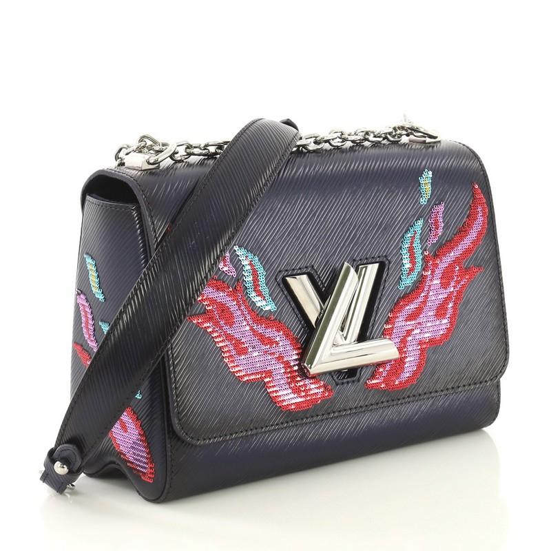 This Louis Vuitton Twist Handbag Epi Leather with Sequins MM, crafted in blue epi leather with sequins, features chain link shoulder strap with leather pad and silver-tone hardware. Its twist-lock closure opens to a blue microfiber interior with