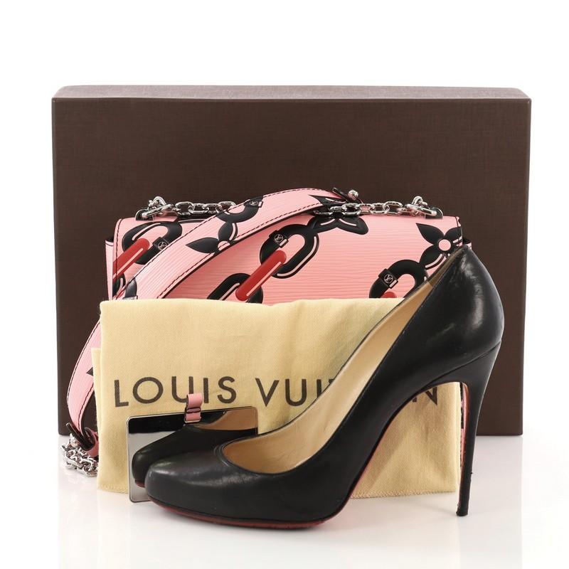 This Louis Vuitton Twist Handbag Limited Edition Chain Flower Print Epi Leather MM, crafted in pink Limited Edition Chain Flower Print epi leather, features a waved base silhouette, chain link strap with leather pad, and silver-tone hardware. Its LV