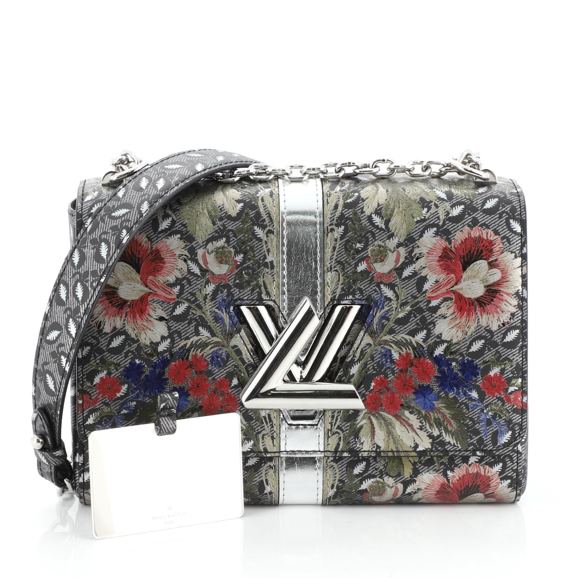 This Louis Vuitton Twist Handbag Limited Edition Floral Print Epi Leather MM, crafted in gray epi leather, features chain-link strap with leather pad, multicolor floral print, and silver-tone hardware. Its LV twist lock closure opens to a black