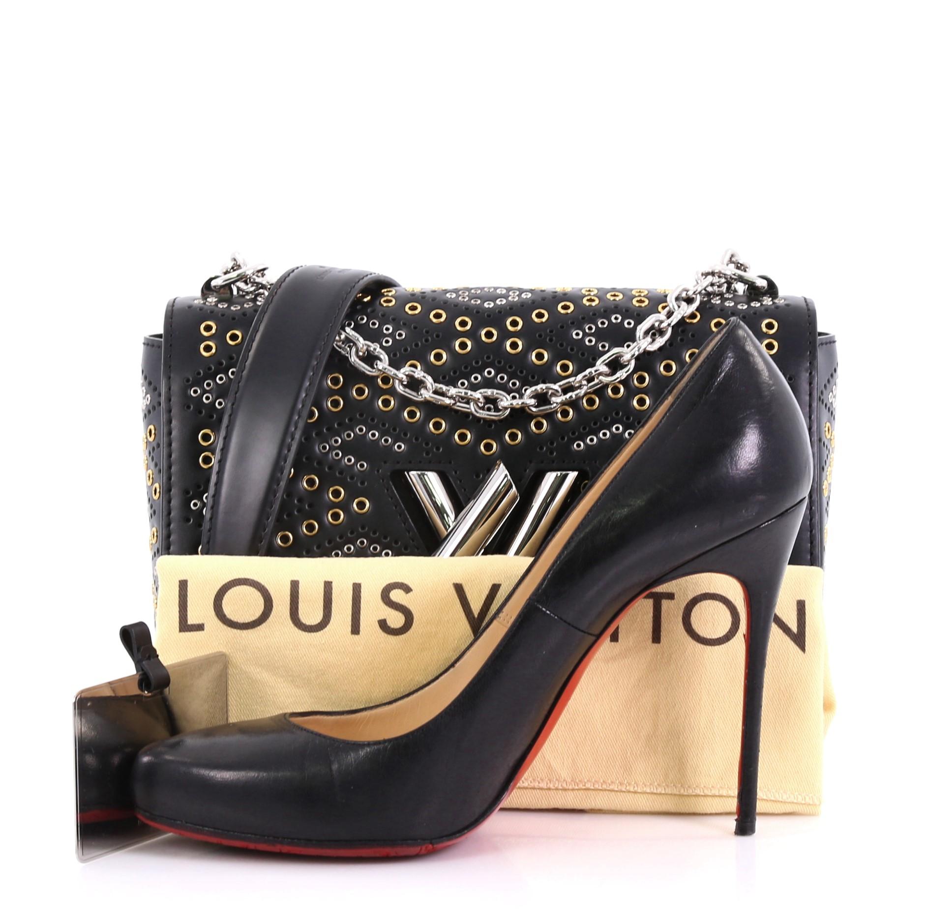 This Louis Vuitton Twist Handbag Limited Edition Grommet Embellished Leather MM, crafted from black grommet embellished leather, features a chain link strap with leather pad, frontal flap, and silver-tone hardware. Its LV twist lock closure opens to