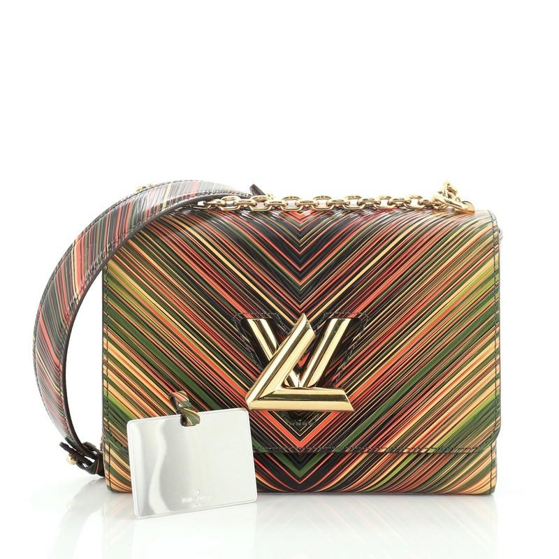 This Louis Vuitton Twist Handbag Limited Edition Tropical Epi Leather MM, crafted from red printed leather, features chain link strap with leather pad, frontal flap, and gold-tone hardware. Its LV twist lock closure opens to a green microfiber