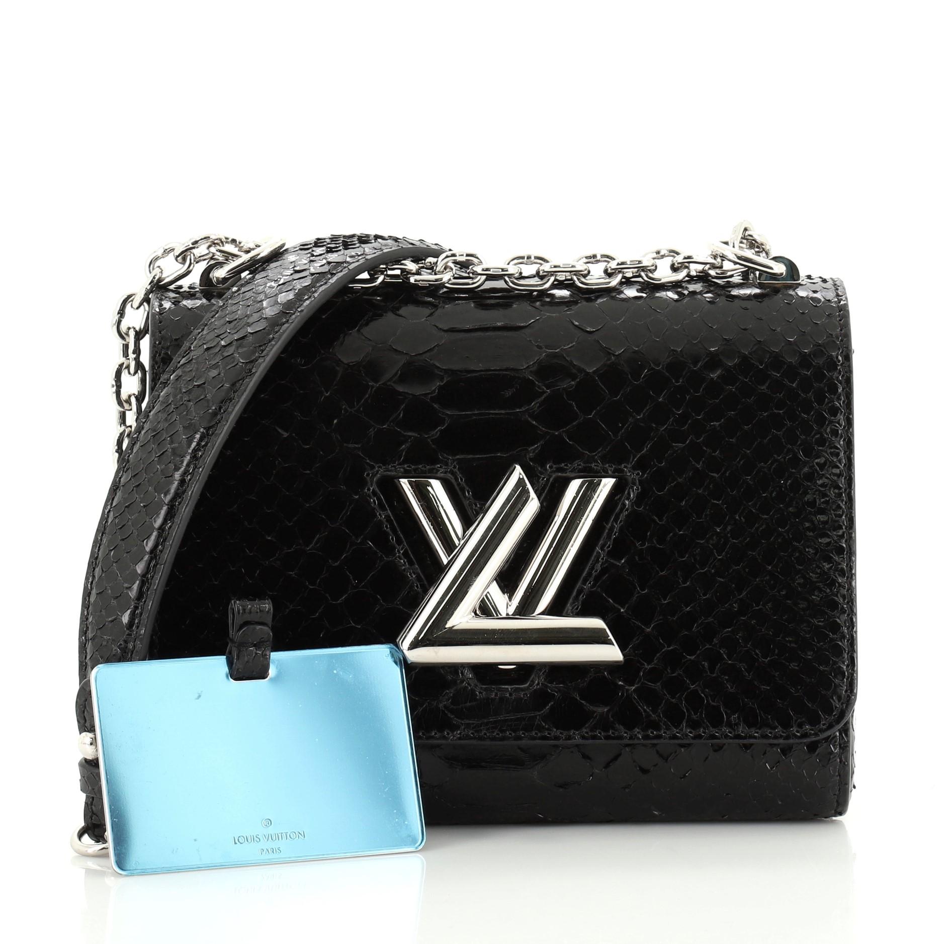 This Louis Vuitton Twist Handbag Python PM, crafted from genuine black python skin, features a chain-link strap with shoulder pads, an LV twist lock and silver-tone hardware. Its twist-lock closure opens to a black leather interior. Authenticity