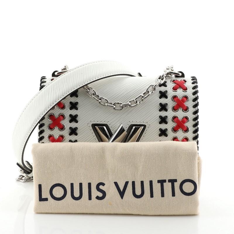 This Louis Vuitton Twist Handbag Whipstitch Epi Leather PM, crafted from white epi leather, features whipstitch detailing, chain link strap with leather pad, frontal flap, and silver-tone hardware. Its LV twist lock closure opens to a black