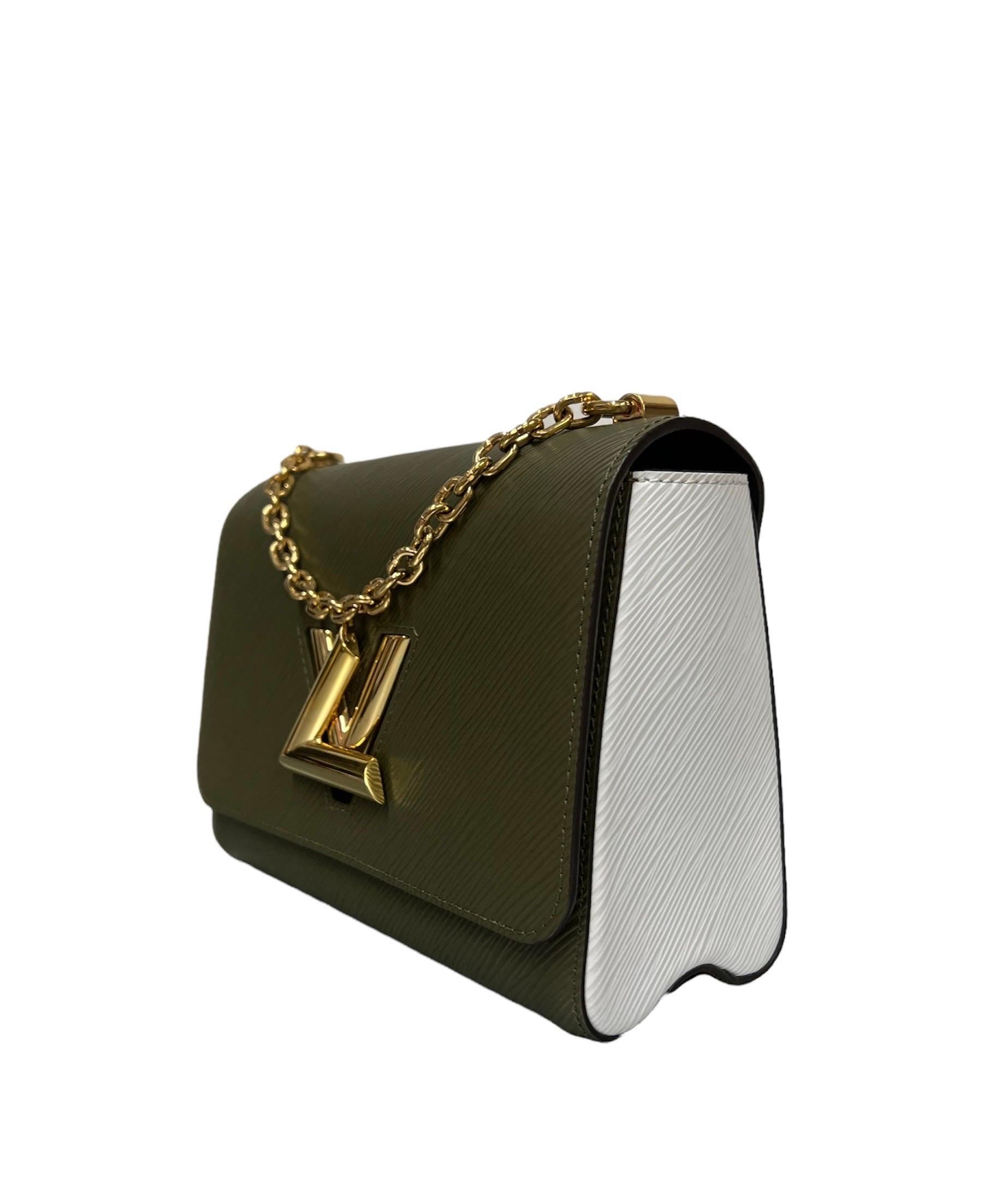 Louis Vuitton bag, Twist line, made of military green and white bicolor epi leather with golden hardware.

Equipped with a flap with LV logo closure, internally lined in black suede, quite roomy.

Equipped with a chain handle and a removable and