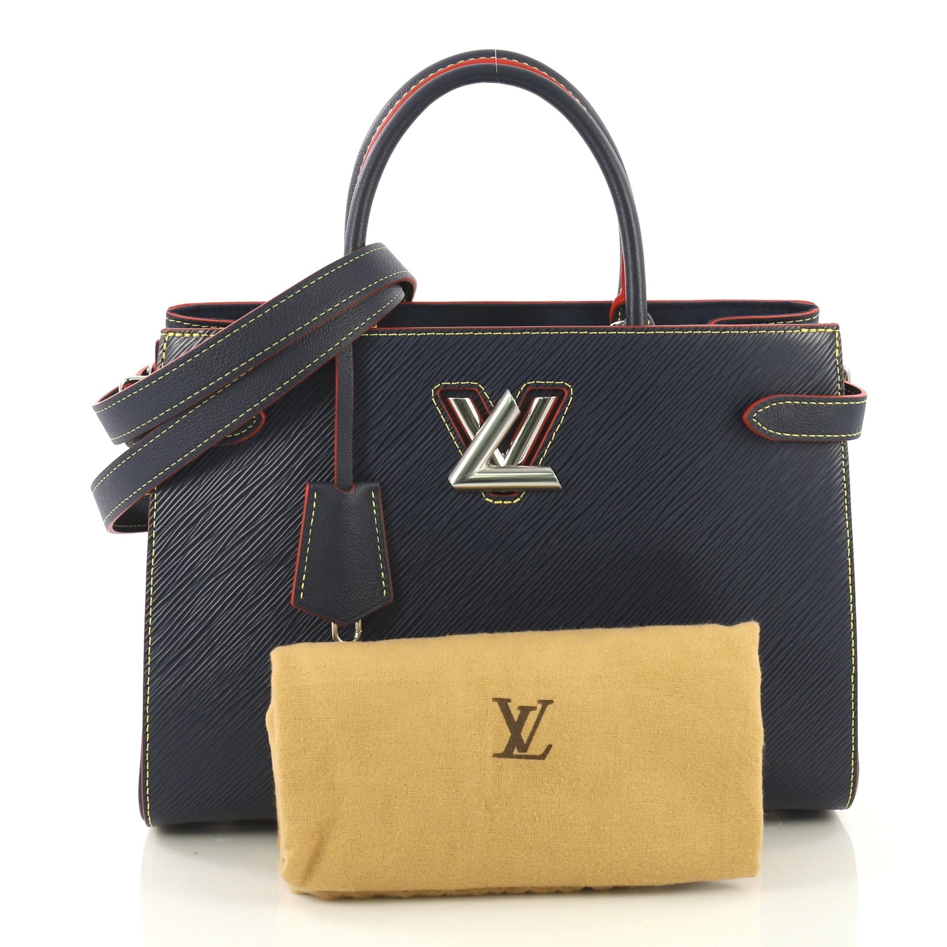 This Louis Vuitton Twist Tote Epi Leather, crafted in blue epi leather, features two Toron handles and silver-tone hardware. Its twist lock closure opens to a blue microfiber interior with two open compartments and a middle zip pocket. Authenticity