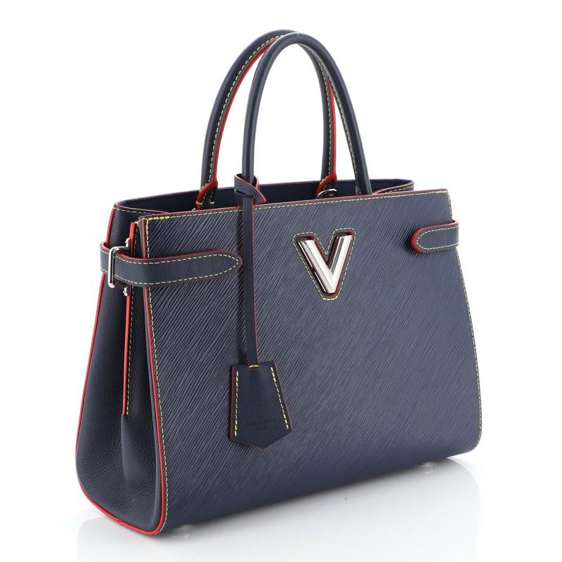 This Louis Vuitton Twist Tote Epi Leather, crafted in blue epi leather, features two toron handles and silver-tone hardware. Its twist-lock closure opens to a blue microfiber interior with two open compartments with slip pockets and a middle zip