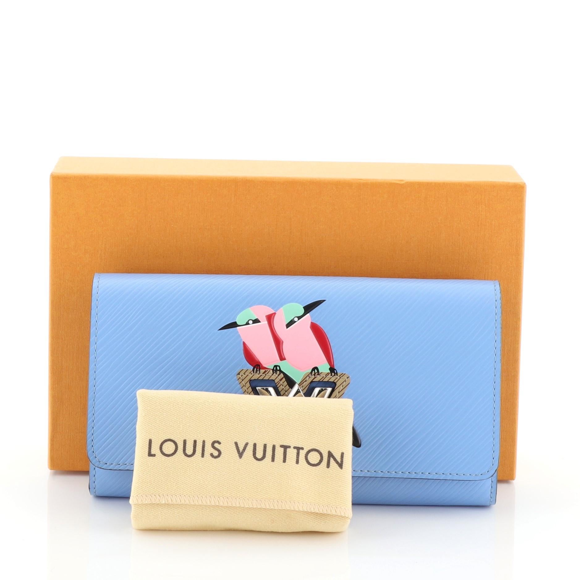 This Louis Vuitton Twist Wallet Bird Motif Epi Leather, crafted in blue epi leather, this wallet features silver LV twist lock, bird motif pattern and silver hardware. Its twist-lock closure opens to a blue leather interior with multiple credit card