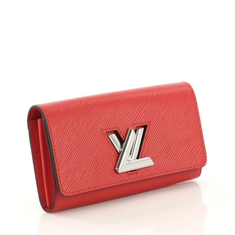 This Louis Vuitton Twist Wallet Epi Leather, crafted from red epi leather, features silver-tone hardware. Its flap with LV twist lock closure opens to a red leather interior with multiple card slots, middle zip pocket, and gusseted main