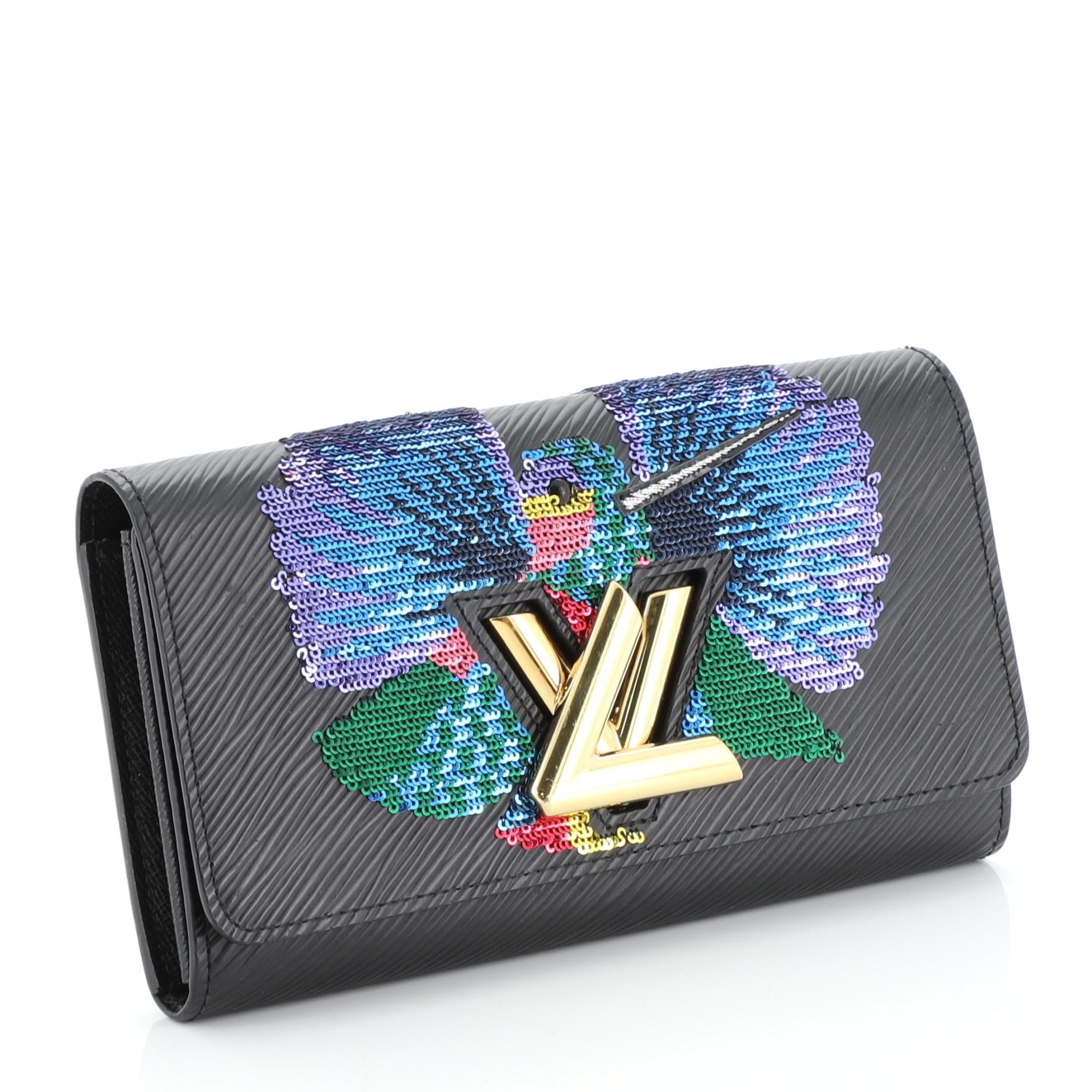 This Louis Vuitton Twist Wallet Epi Leather with Sequins, crafted in black epi leather with multicolor sequins, features gold-tone hardware. Its twist-lock closure opens to a black leather interior with multiple card slots and zip pocket.