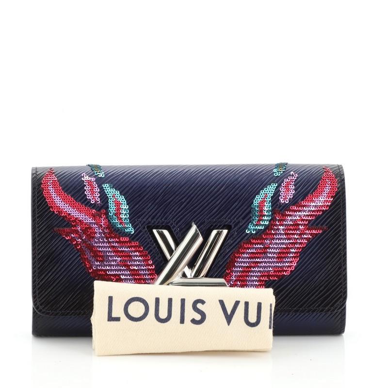 This Louis Vuitton Twist Wallet Epi Leather with Sequins, crafted in blue epi leather with sequins, features silver-tone hardware. Its twist-lock closure opens to a blue leather interior with multiple card slots and zip pocket. Authenticity code