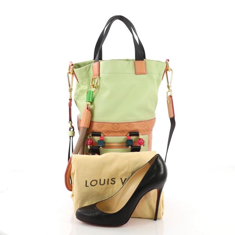 This Louis Vuitton Underground Duffle Bag Monogram Empreinte Leather, crafted in pink monogram Empreinte and green leather, features an adjustable flat shoulder strap, four flat top handles (two with multicolor resin adornments), exterior zip pocket