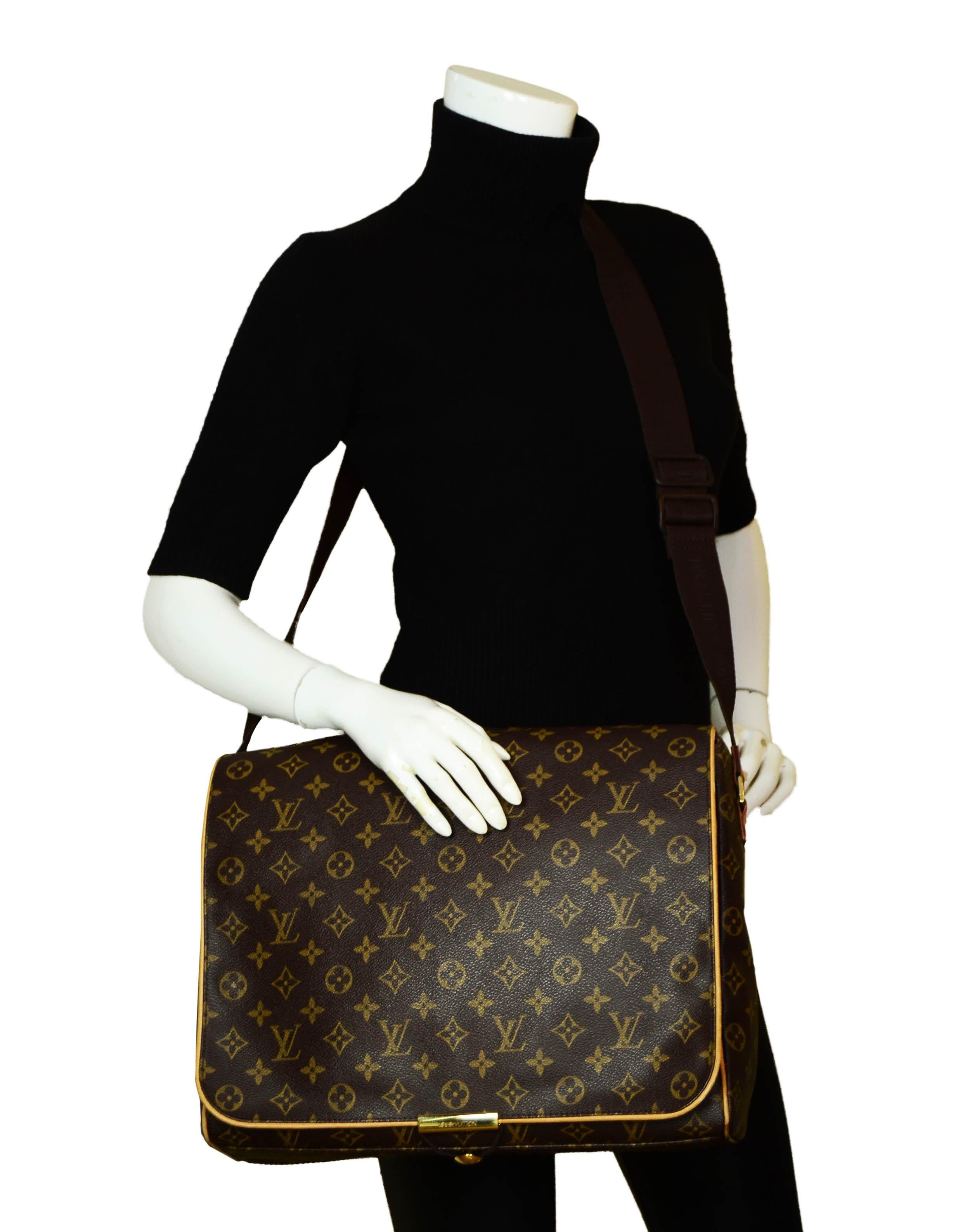Louis Vuitton Monogram Abbesses Messenger Bag.  Features back leather piece to slide onto rolling luggage.  

Made In: France
Year of Production: 2002
Color: Brown monogram
Hardware: Goldtone
Materials: Coated canvas
Lining: Canvas
Closure/Opening: