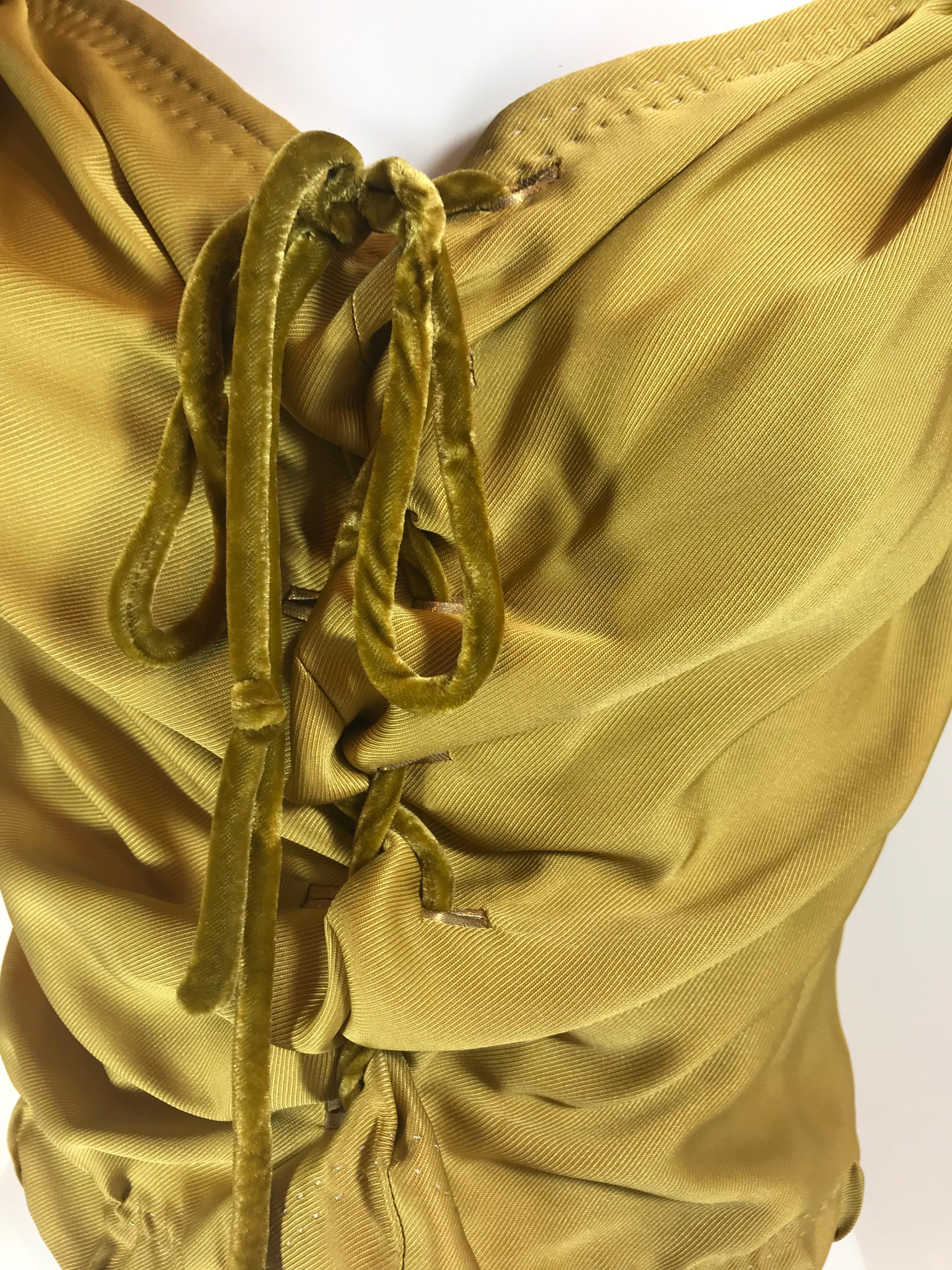 Mustard sleeveless top with V-neck featuring velvet tie accents at front, and zip closure at back. Size can be slightly loosened or tightened. (Measured with slightly tied.)