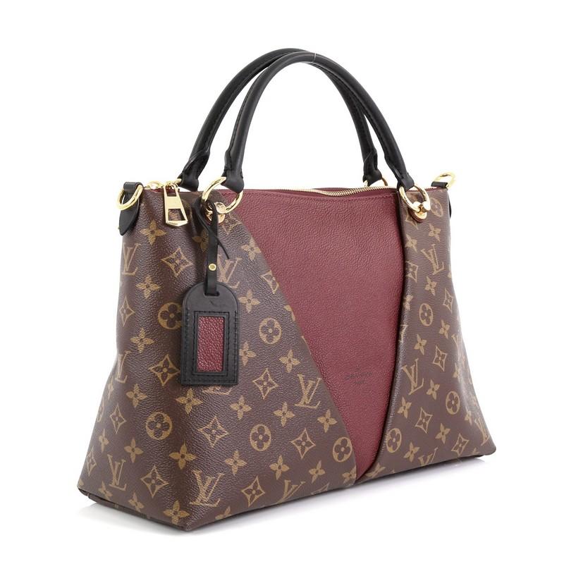 This Louis Vuitton V Tote Monogram Canvas and Leather MM, crafted from brown monogram coated canvas and leather, features dual rolled handles and gold-tone hardware. Its zip closure opens to a red microfiber interior with slip pockets. Authenticity