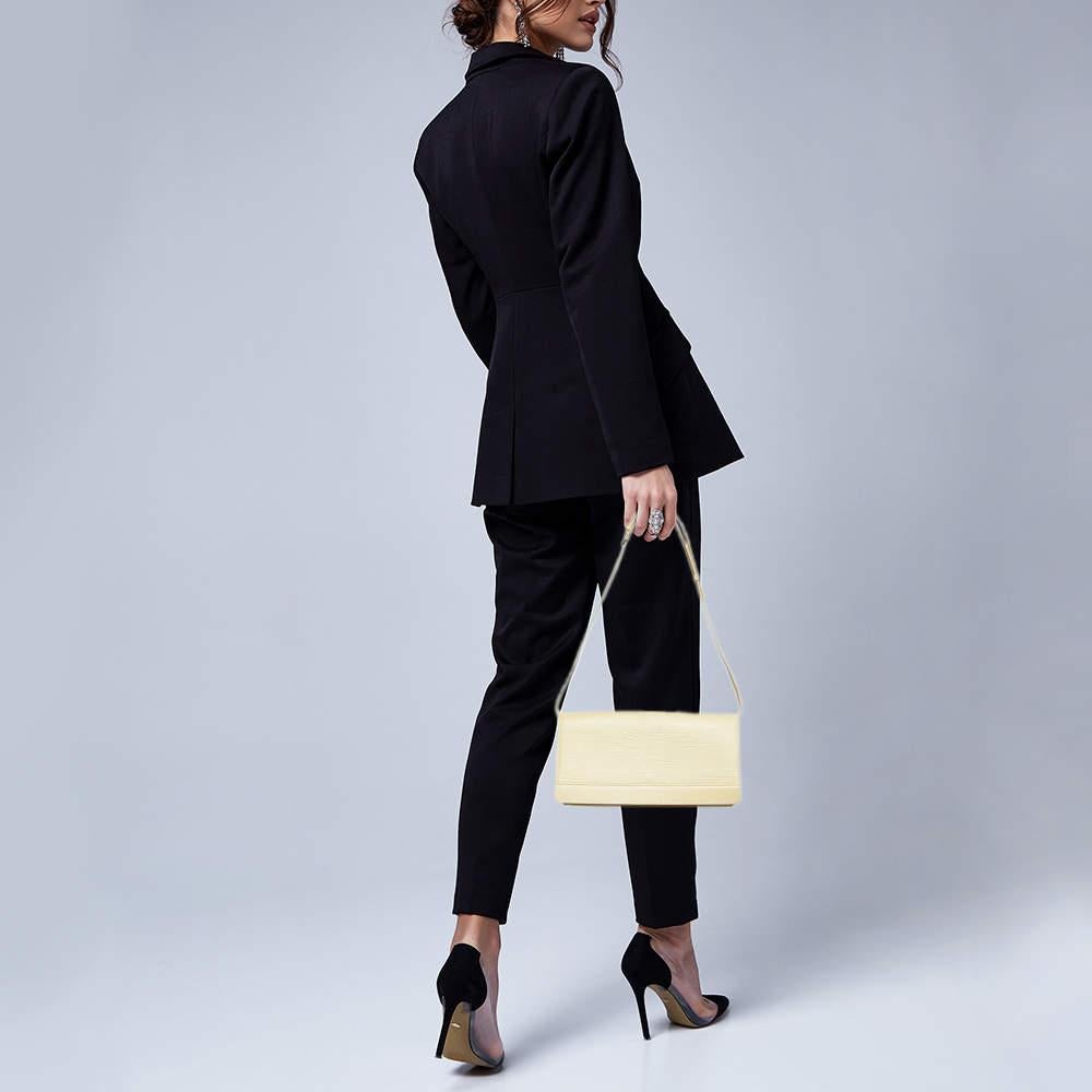 Louis Vuittons Honfleur clutch is high on style and functionality. The sleek design has been crafted from signature epi leather and equipped with a spacious Alcantara lined interior that will hold all your small belongings. The bag is complete with