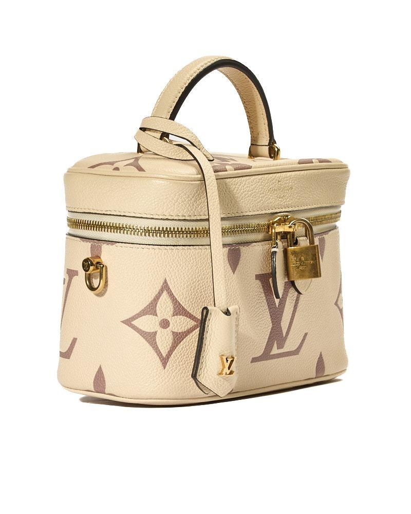 Louis Vuitton signature bag, Vanity model in PM size, made of empreinte leather in cream color with giant monogram and gold hardware. Features a semi-circular double-slider zipper closure, internally lined in tone-on-tone suede fabric with