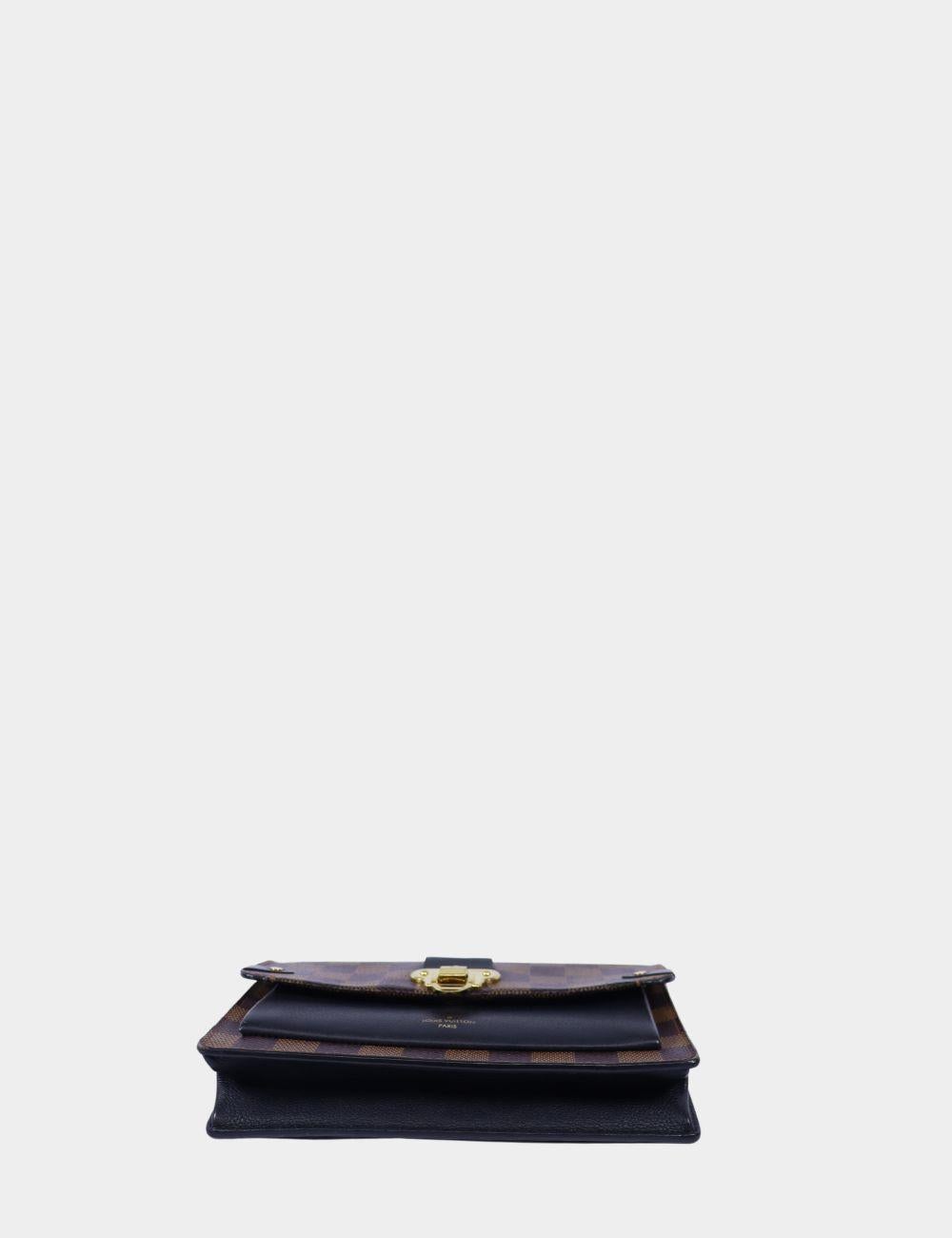 A timeless classic with Parisian edge, this Louis Vuitton Damier Ebene chain wallet features the iconic checkered canvas paired with luxurious dark leather trim and gold-tone hardware. The elegant S-lock closure offers a vintage-inspired touch,