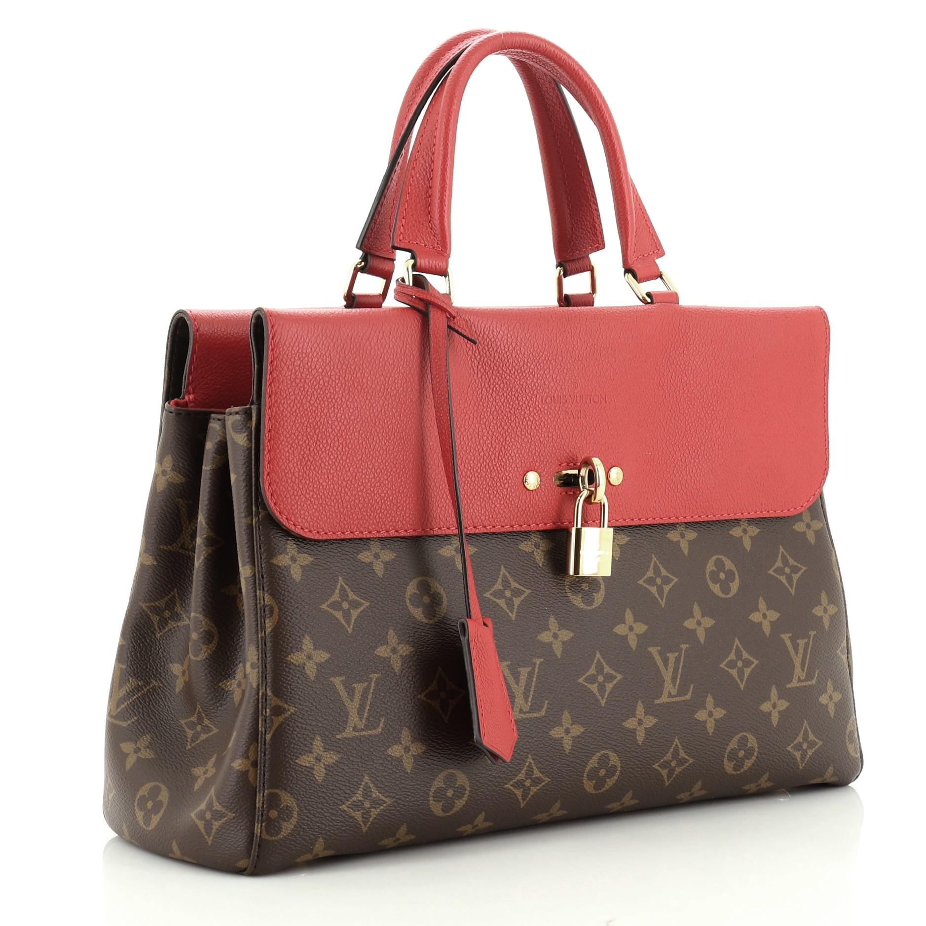 This Louis Vuitton Venus Handbag Monogram Canvas and Leather, crafted from brown monogram coated canvas and red leather, features dual leather handles, exterior front and back compartments, and gold-tone hardware. Its hook clasp closure opens to a