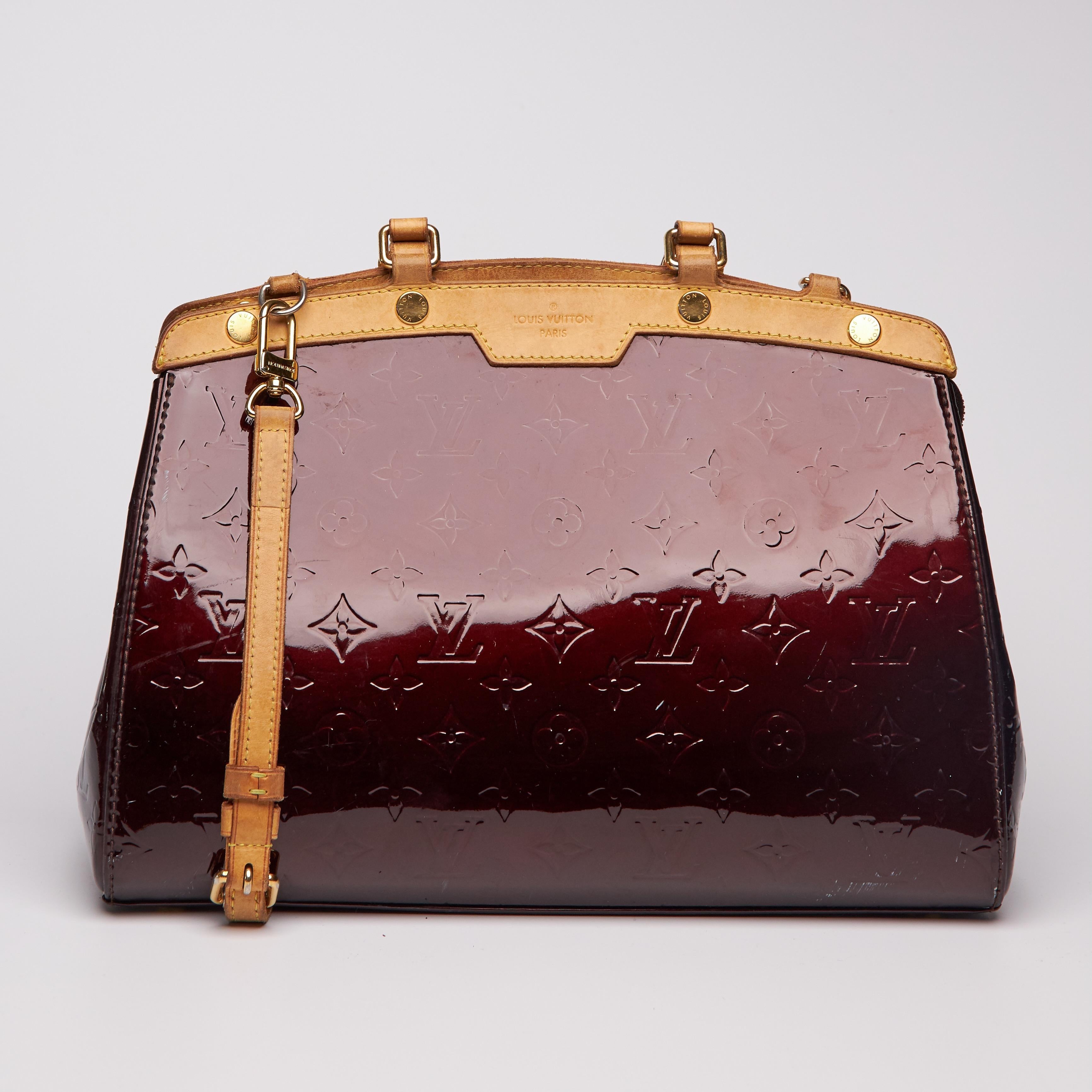 
This bag has a rich deep purple Louis Vuitton embossed vernis patent leather. The bag is lined in vachetta cowhide leather including top handles and an optional vachetta shoulder strap. The bag has brass hardware including handle rings, four feet