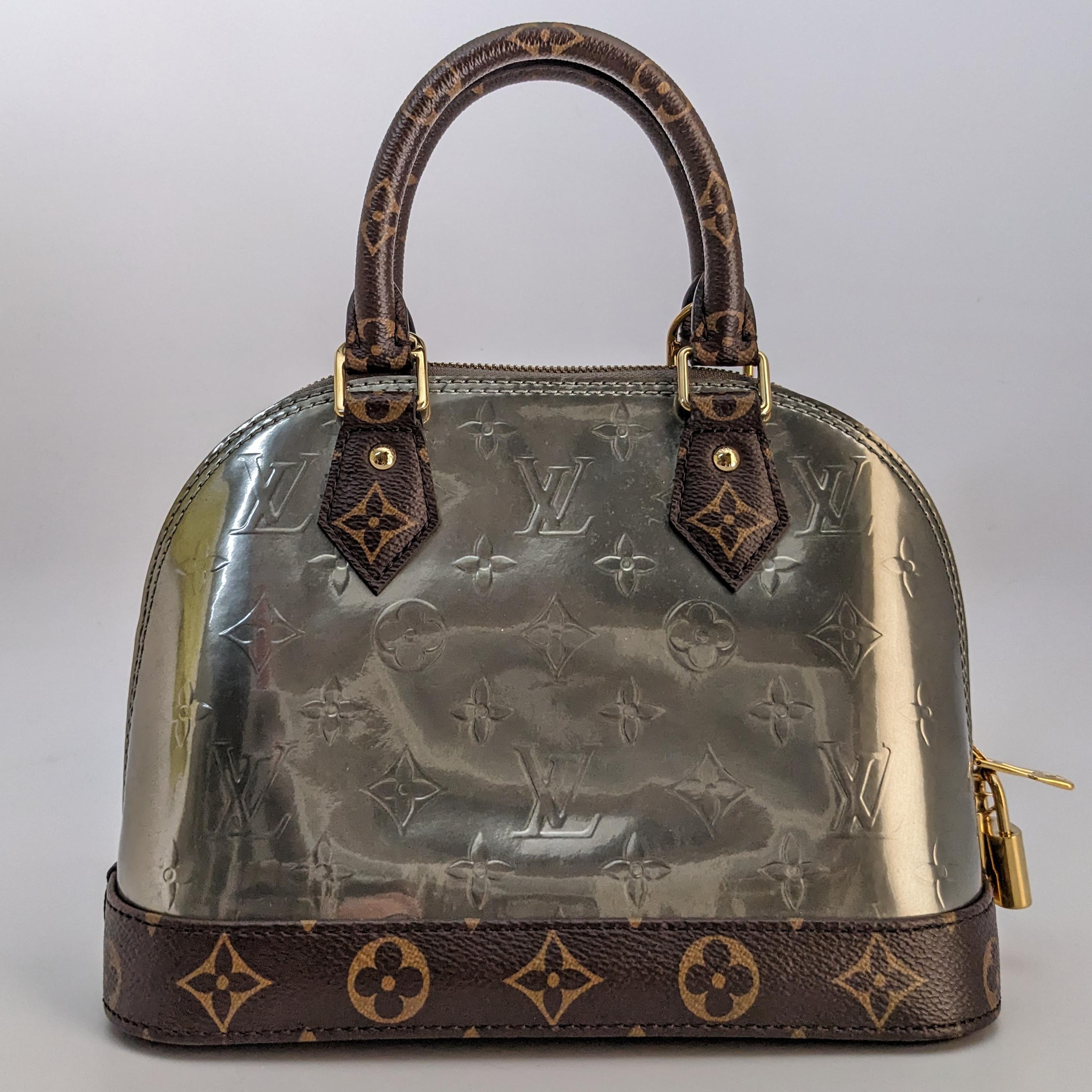 Condition: This authentic Louis Vuitton bag is in great pre-loved condition. There are light marks to the exterior and minor handle indents on front and back.

Includes: Clochette, long strap

Features: The bag features monogram coated canvas top