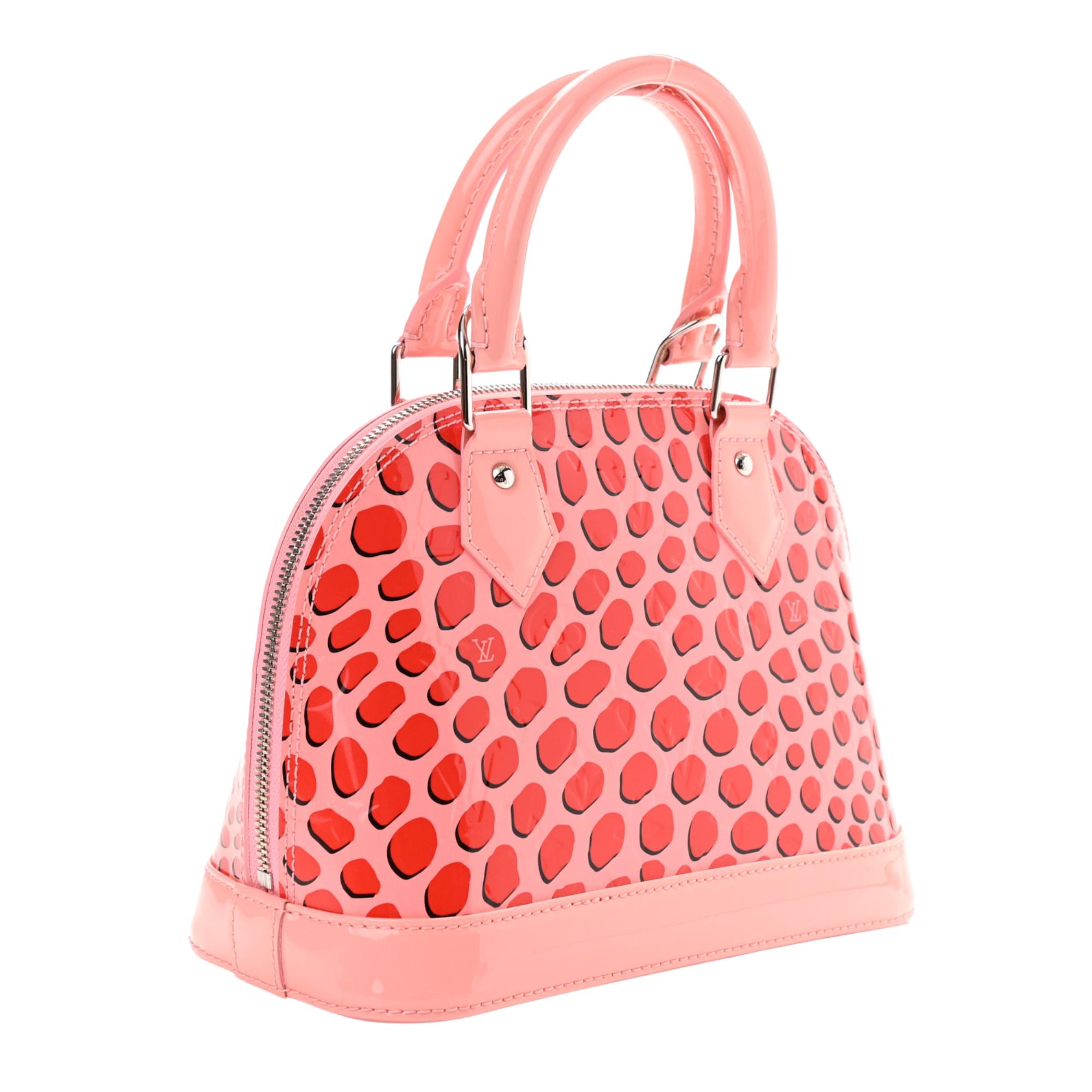 This style of patent leather monogram embossed bags are named Vernis as the French word for varnish is “vernis”.  

This fun bag is made of glossy monogram vernis patent leather in light pink. It features jungle dots in red and polished silver
