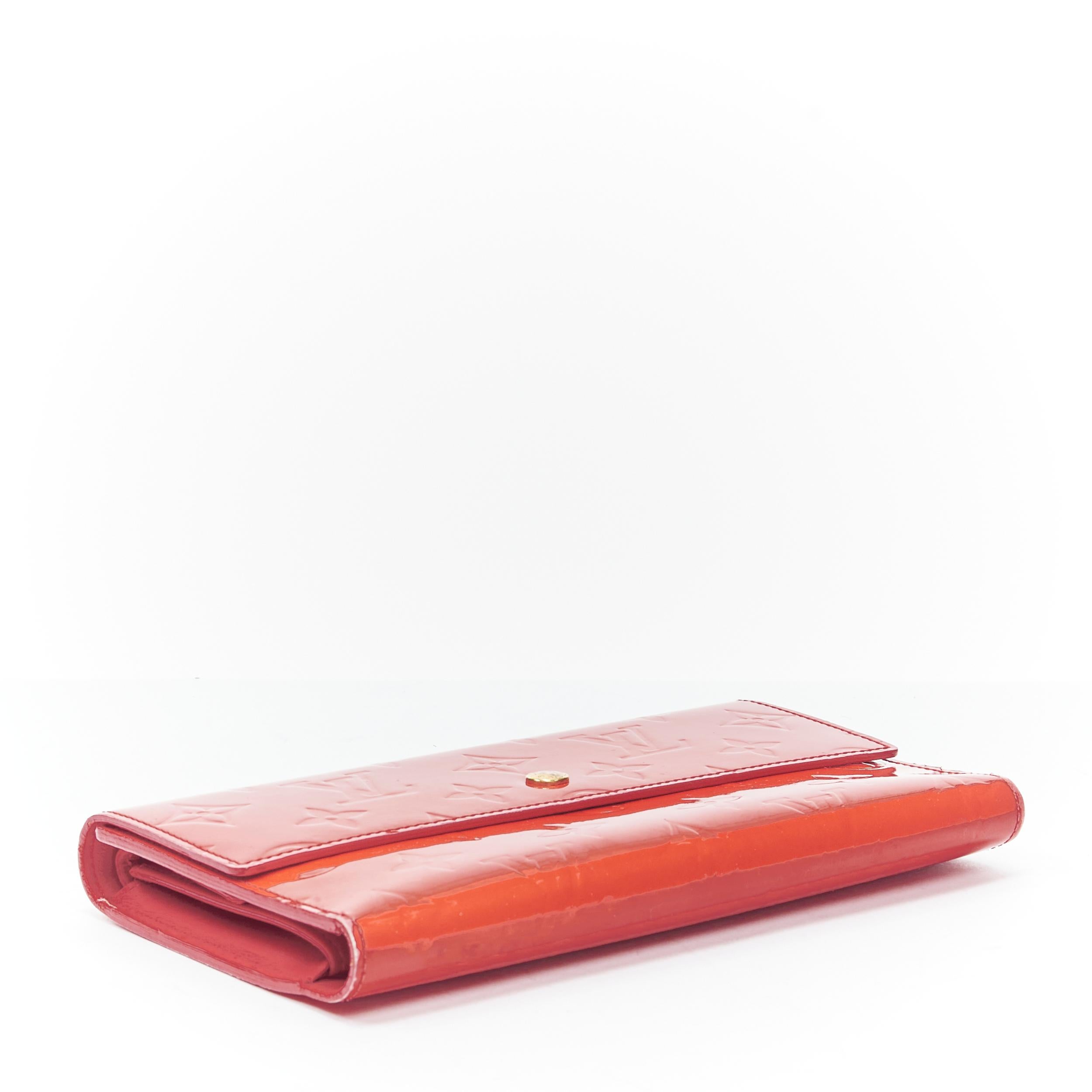 LOUIS VUITTON Vernis red patent LV logo emboss flap continental wallet 
Reference: TGAS/B01410 
Brand: Louis Vuitton 
Material: Patent Leather 
Color: Red 
Pattern: Solid 
Closure: Button 
Extra Detail: Red vernis patent. Monogram emboss. Gold-tone