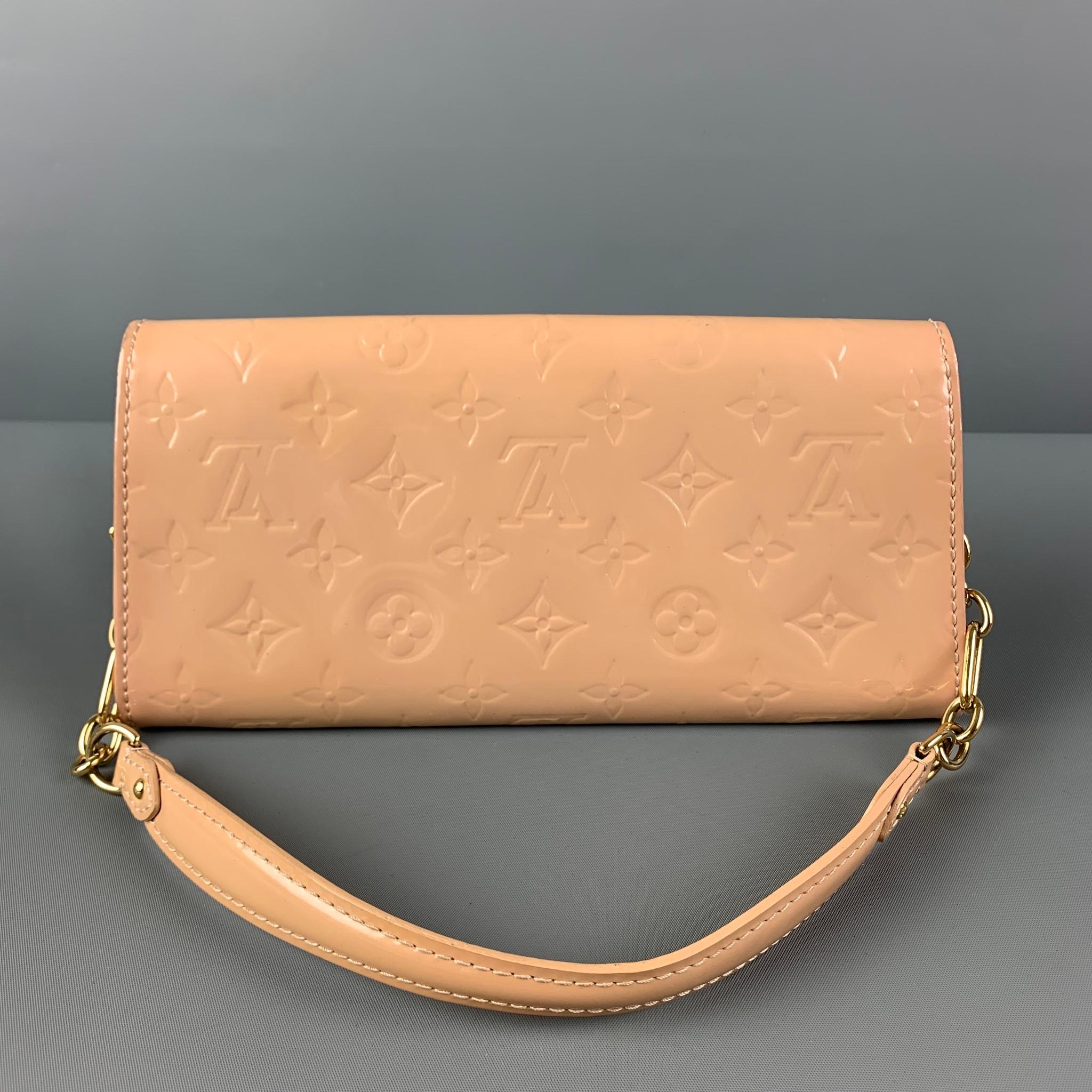 LOUIS VUITTON 'Vernis Sunset Boulevard' clutch comes in a beige embossed monogram patent leather featuring a front logo plaque, gold tone hardware, inner slots, detachable chain, and a snap button closure. Includes dust bag. Made in France.

Very