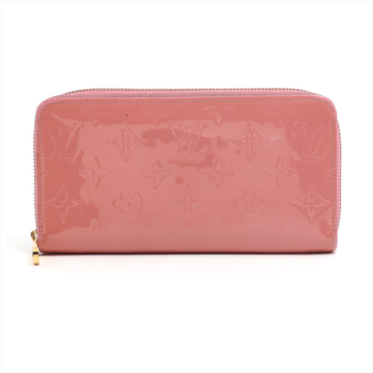 The Louis Vuitton Vernis Zippy Long Wallet in Rose Ballerine is a luxurious and stylish accessory that exudes elegance and sophistication. Crafted from glossy Vernis patent leather, the wallet features a beautiful soft pink hue. The iconic LV