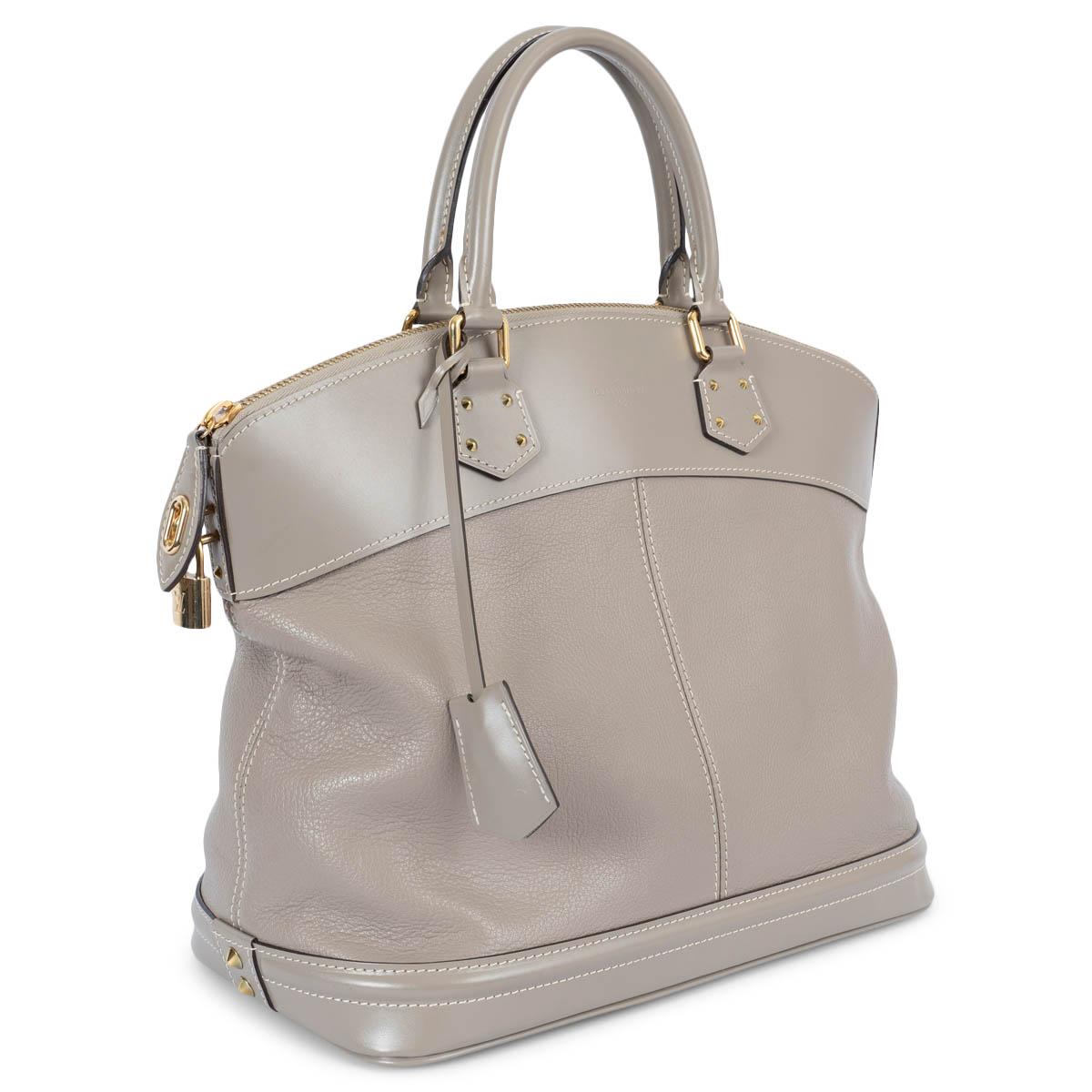 100% authentic Louis Vuitton Lockit MM handbag in taupe Suhali leather and hardware in gold-tone metal. The design features a zipper closure and is lined in taupe logo nylon with one zip pocket against the back and two open pockets against the