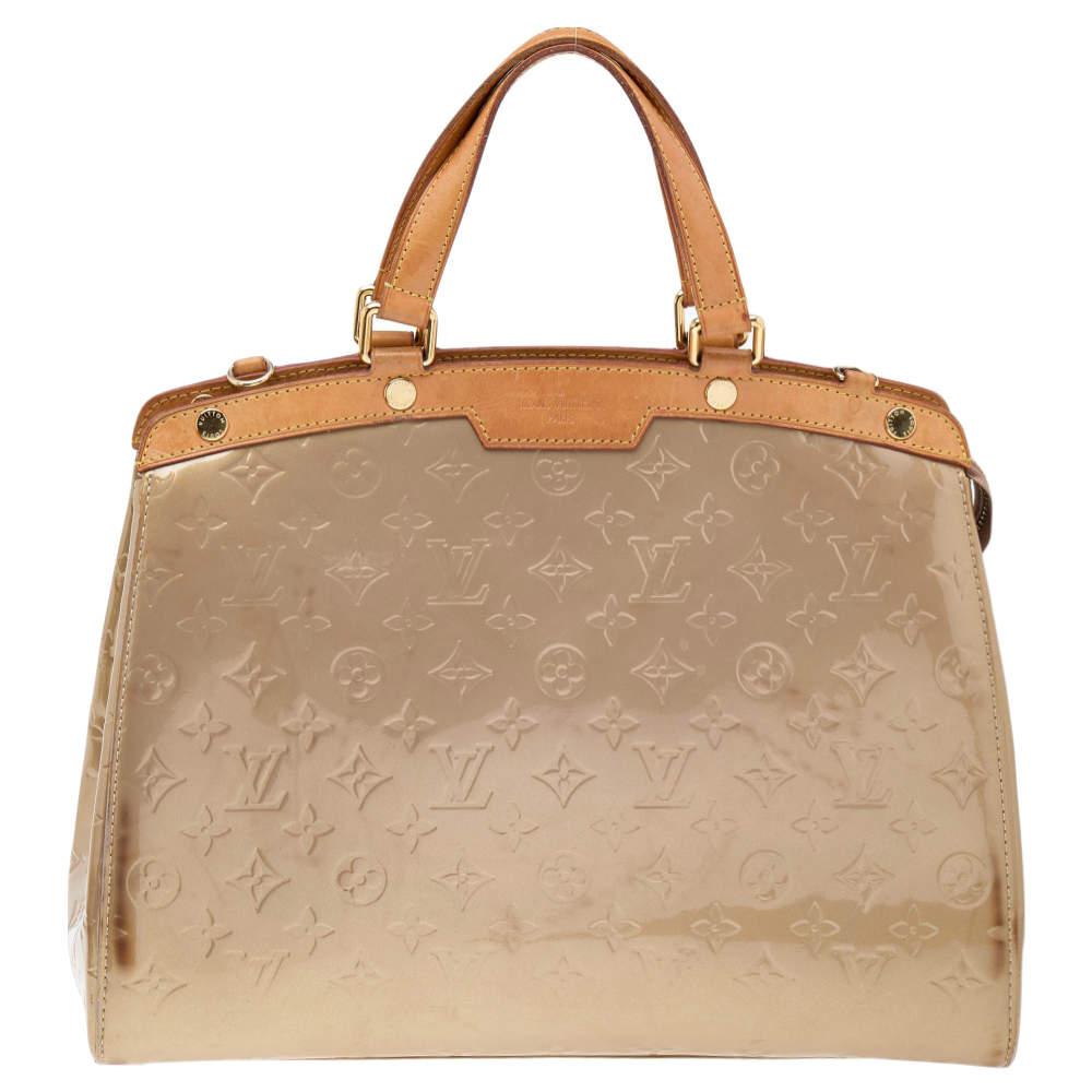 The feminine shape of Louis Vuitton's Brea is inspired by the doctor's bag. Crafted from Monogram Vernis leather, the bag has a perfect finish. The fabric interior is spacious and it is secured by a zipper. The bag features double handles, a
