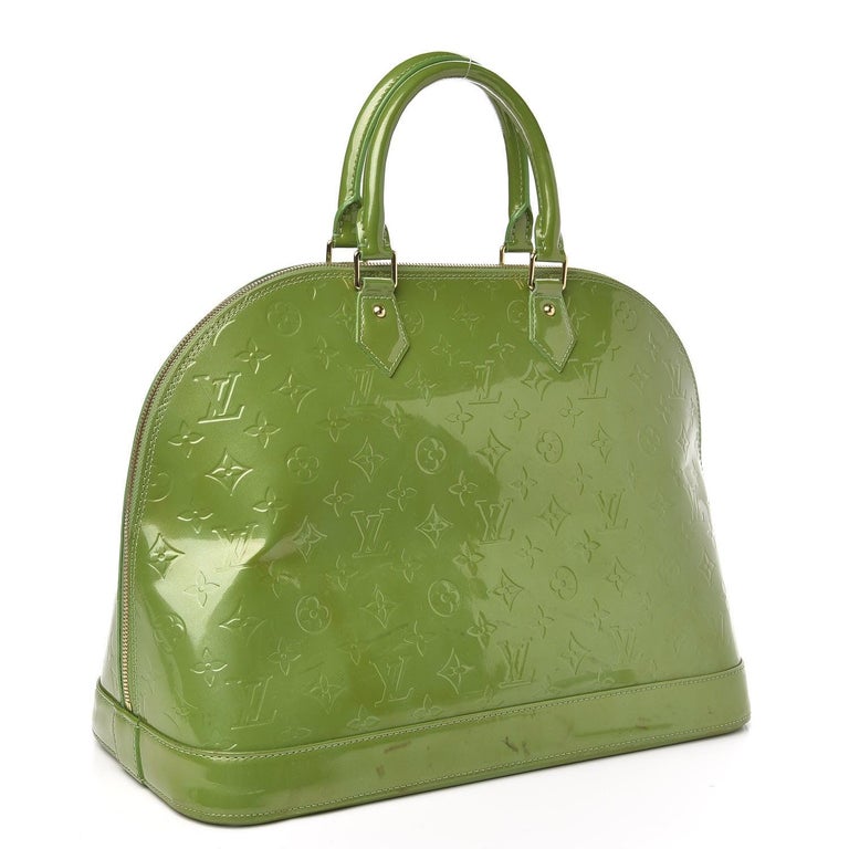 Louis Vuitton Alma GM Bag is crafted from green Vernis Monogram leather, gold-tone hardware and dual top handles and protective studs at base. The double zip closure opens to a roomy interior with leather lining.

 

63490MSC