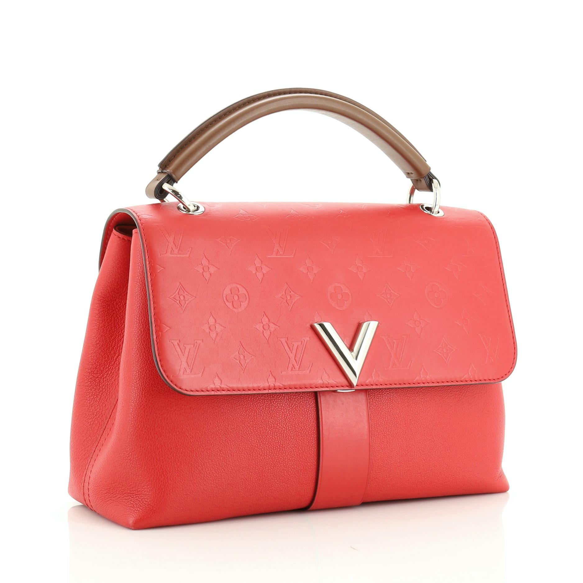 This Louis Vuitton Very One Handle Bag Monogram Leather, crafted in red monogram leather, features rolled leather handle, V logo at front flap and silver-tone hardware. Its flap opens to a red microfiber interior divided into two compartments with a