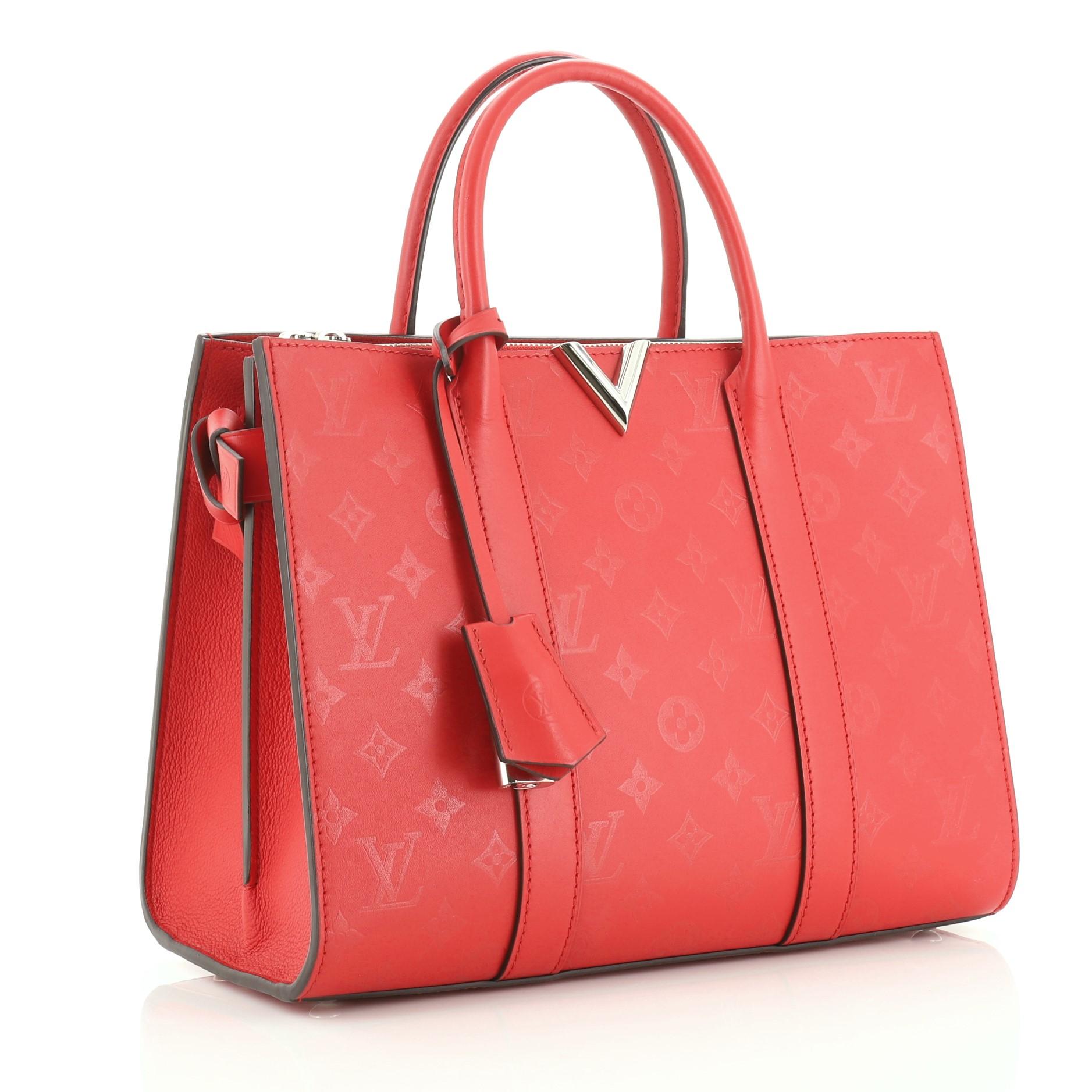This Louis Vuitton Very Tote Monogram Leather MM, crafted in red monogram leather, features dual rolled handles and silver-tone hardware. It opens to a red microfiber interior with middle zip compartment. Authenticity code reads: DR4187.

Estimated
