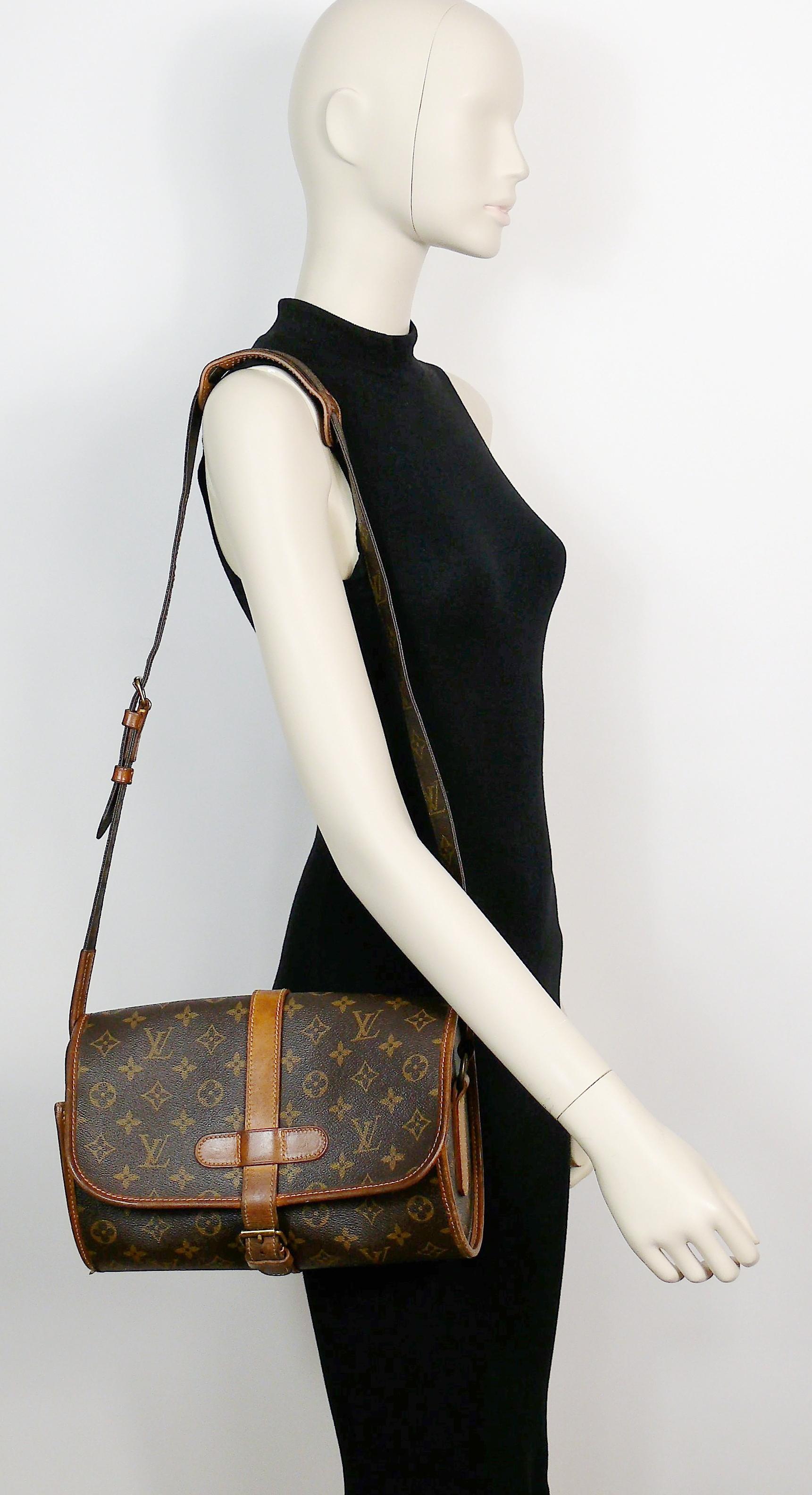 LOUIS VUITTON vintage 1990 MARNE bag featuring the iconic monogram coated canvas print with leather details.

Leather belt closure on the front.
Adjustable strap that allows to worn the bag across the body or on one shoulder. 
Brown lining.
One