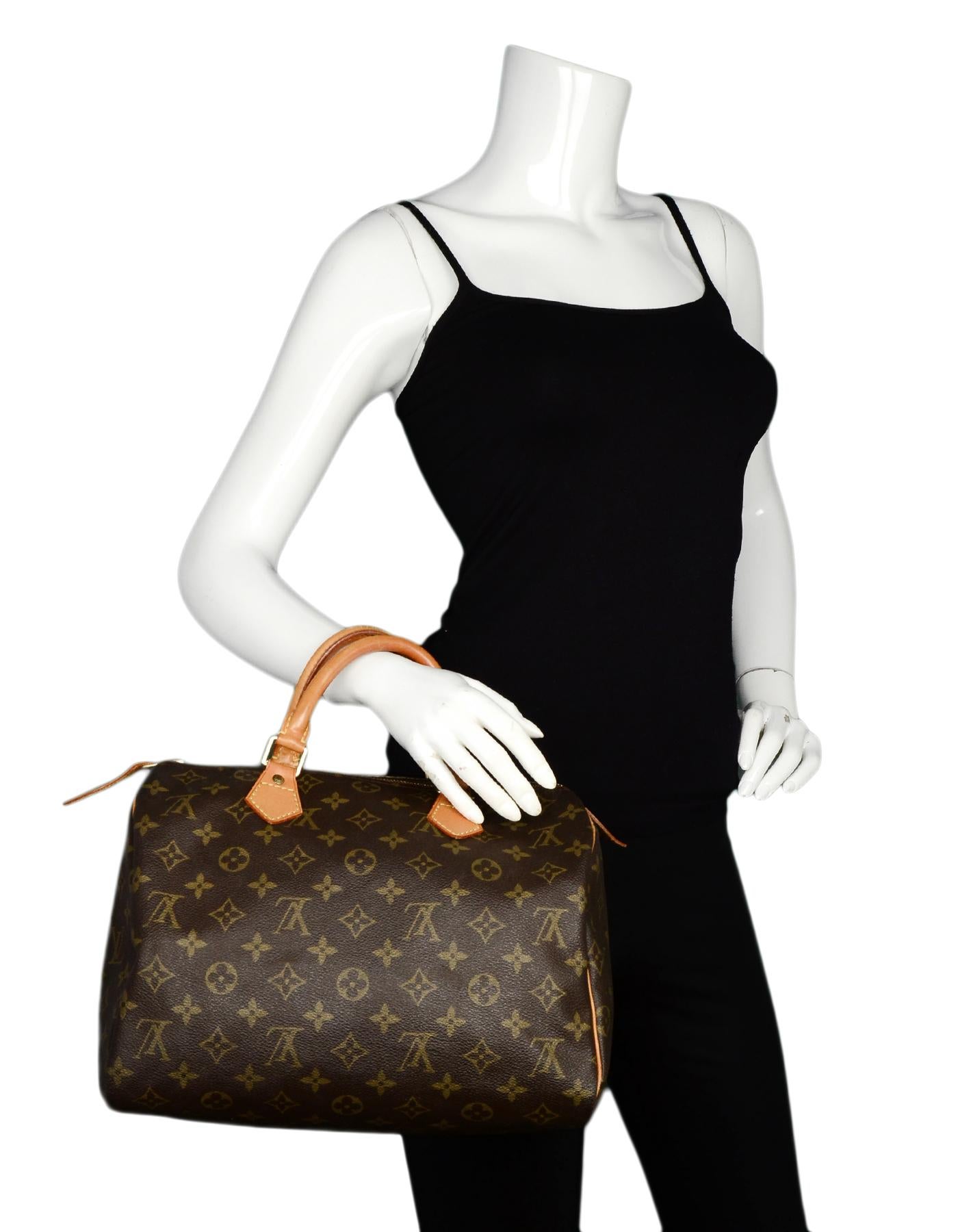 Louis Vuitton Vintage 90's LV Monogram Canvas Speedy 30 Bag

Made In: France
Year of Production: 1995
Color: Brown
Hardware: Goldtone
Materials: Coated canvas, leather, metal
Lining: Brown canvas
Closure/Opening: Zip top
Exterior Pockets: