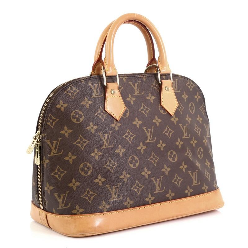 This Louis Vuitton Vintage Alma Handbag Monogram Canvas PM, crafted from brown monogram coated canvas, features dual rolled handles and gold-tone hardware. Its two-way zip closure opens to a brown fabric interior with slip pocket. Authenticity code