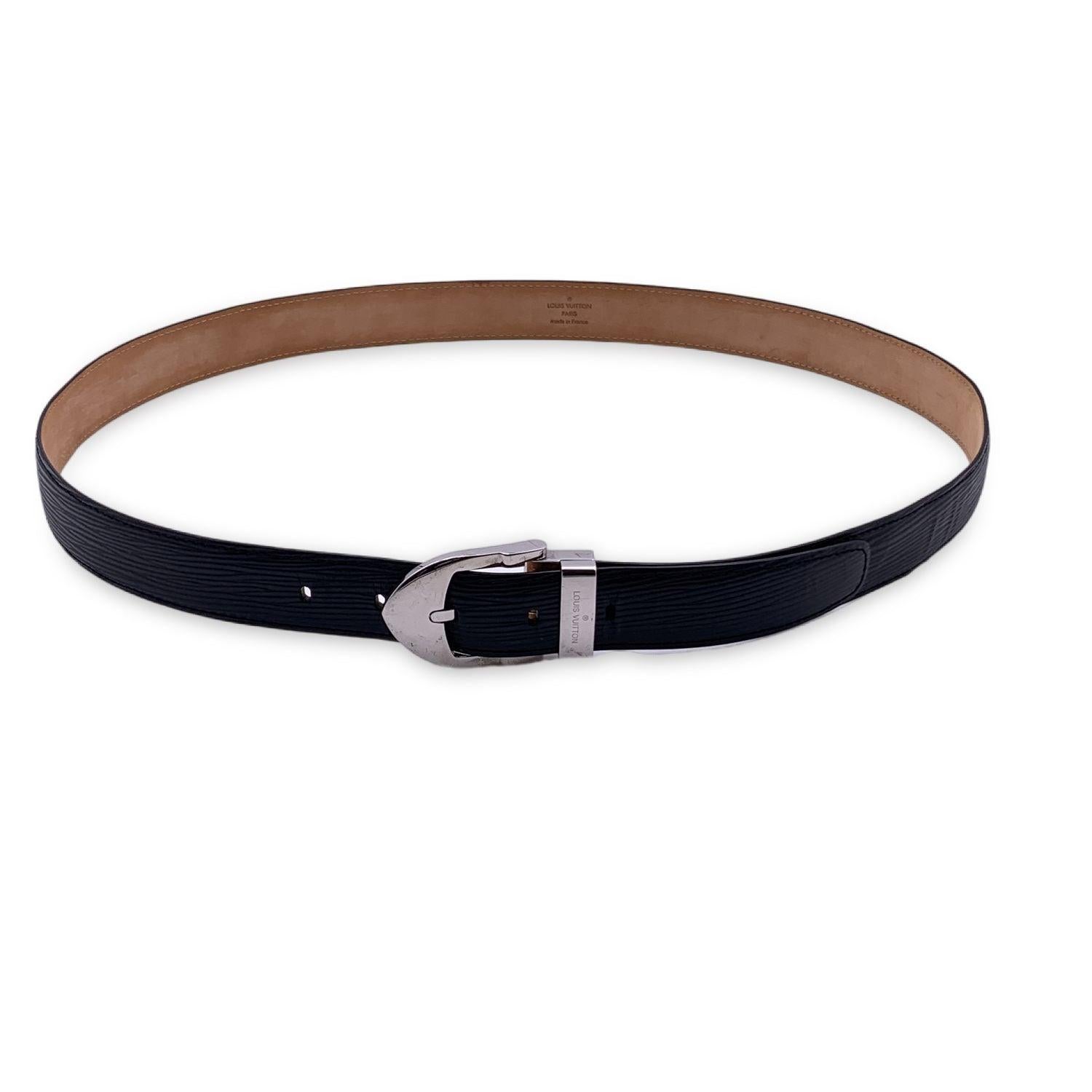 LOUIS VUITTON black epi leather belt. The belt features asilver metal buckle with engraved 'Louis Vuitton' signature. Five holes adjustment. Size 110/44. Width: 1.1 inches - 2.5 cm. Total length: 48 inches - 122 cm (only leather). From first notch