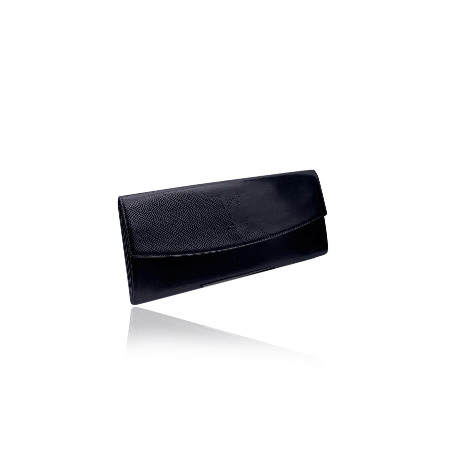 Louis Vuitton vintage black leather Opera Egee clutch. Black Leather, with epi leather detailing on the flap and big LV logo. Flap with button closure on the front, 3 compartments inside. Rear handle. 'LOUIS VUITTON' engraved under the flap. 'Made