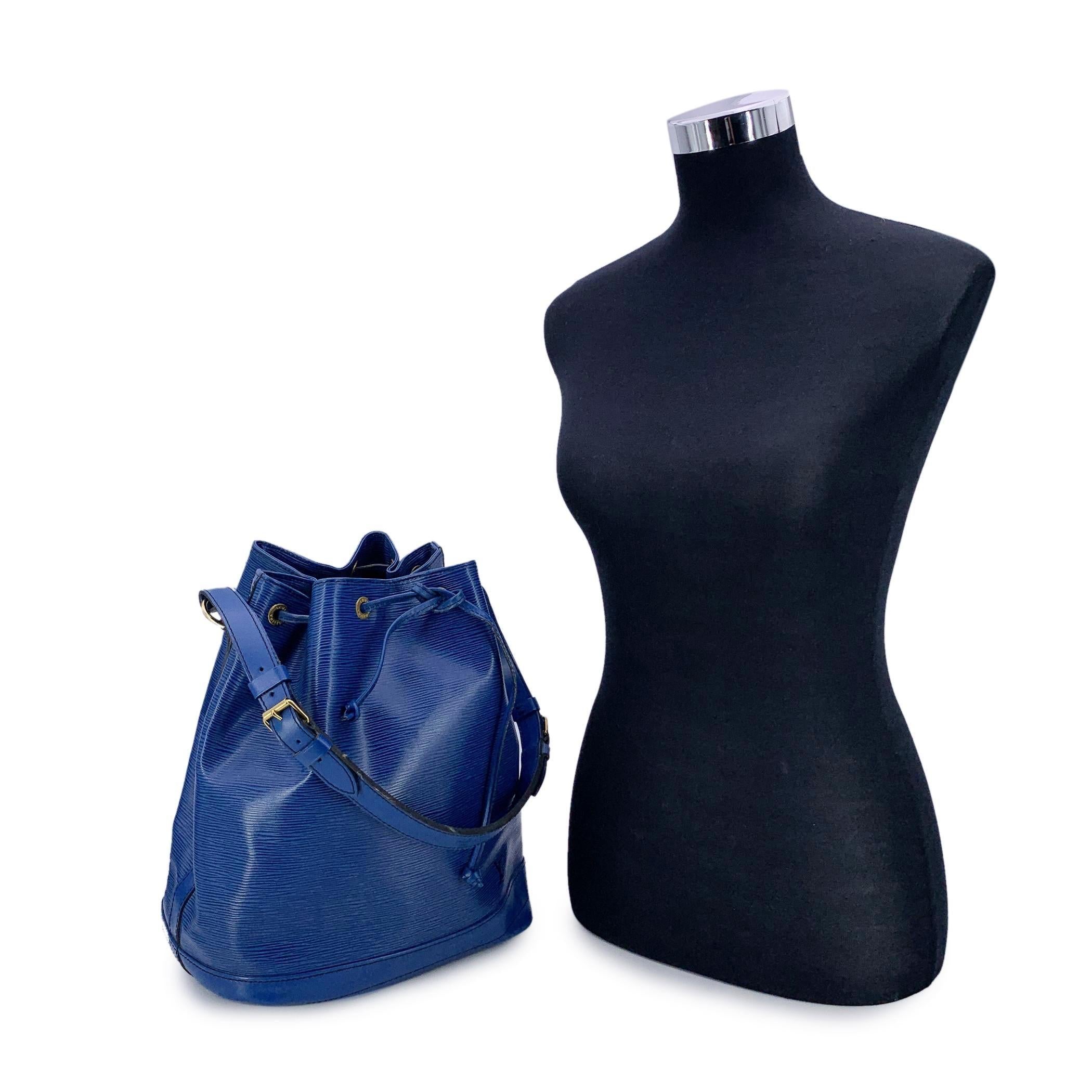 Iconic 'Noé' bucket bag by LOUIS VUITTON was first created in 1932 to carry champagne bottles. Blue Epi leather with smooth leather trim at the bottom, with drawstring closure and microfiber lining. 1 D-Ring inside. Adjustable shoulder strap. LV -