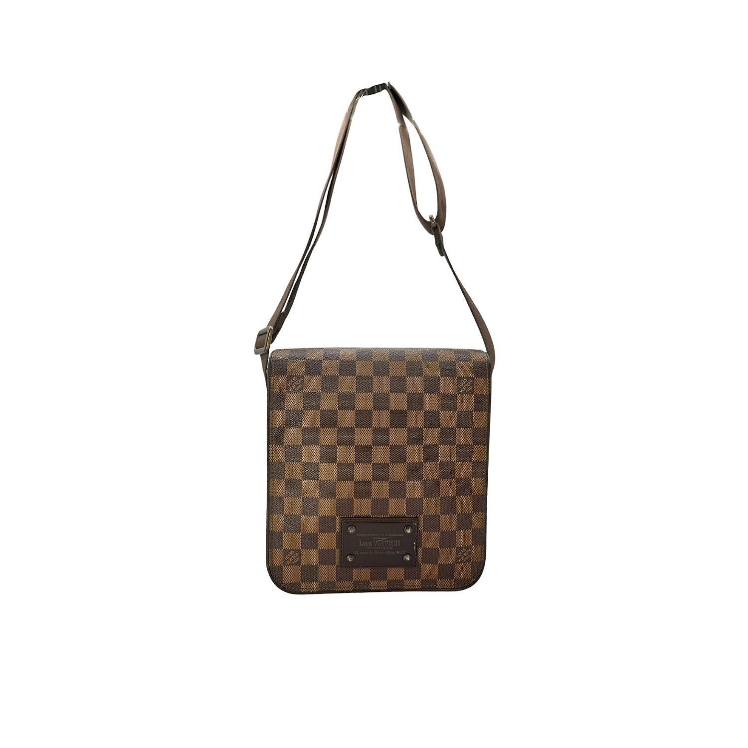 Experience luxury and style with the Louis Vuitton Brooklyn messenger bag. Crafted from durable Damier Ebene canvas, this bag features a spacious interior with patch pockets for easy organization. The brown hardware and adjustable strap add a chic