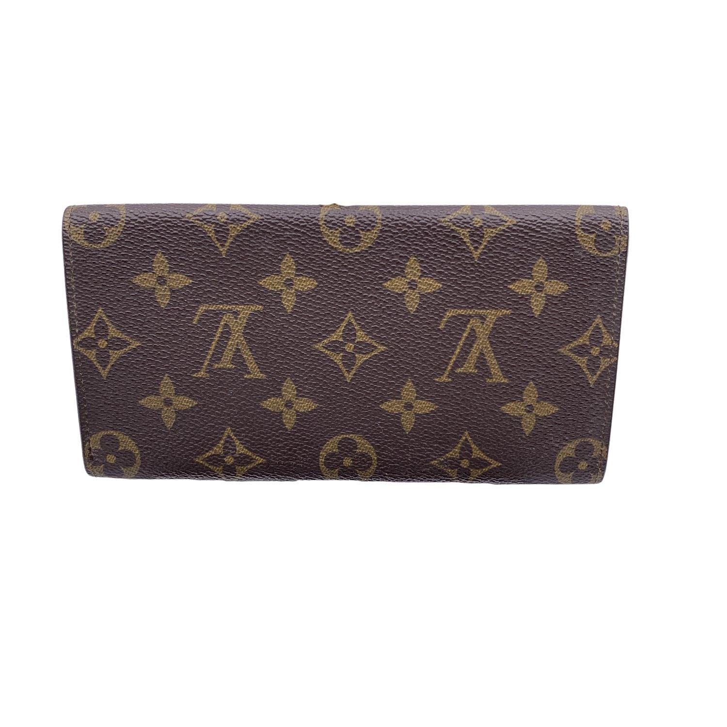 Vintage Louis Vuitton brown monogram canvas Long Bifold Bill Wallet. Flap closure. Leather lining. 1 main compartments inside. 1 open pocket under the flap. 'LOUIS VUITTON Paris - made in France' engraved inside. Details MATERIAL: Cloth COLOR: Brown