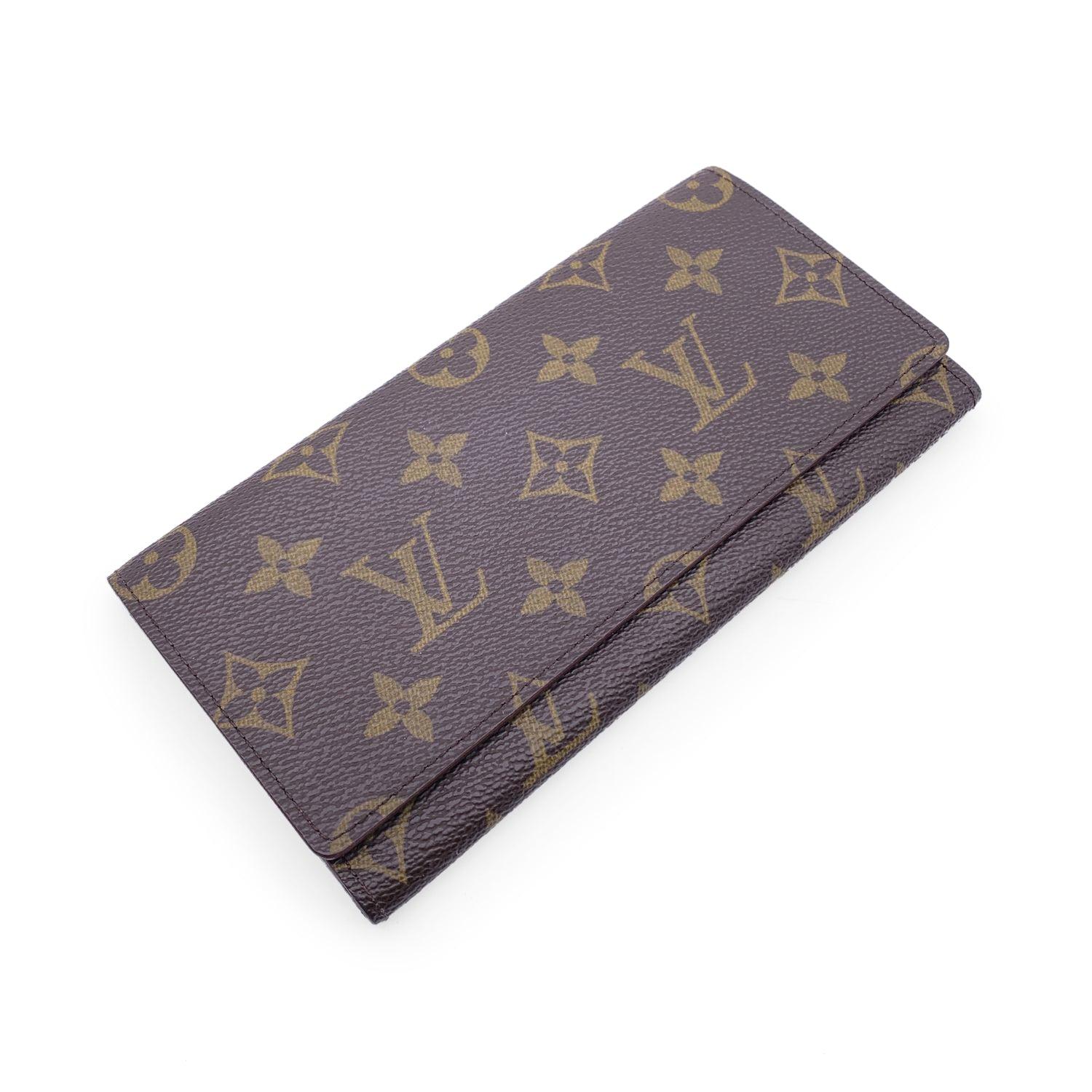 Vintage Louis Vuitton brown monogram canvas Long Bill Wallet. Flap closure. Leather lining. 1 main compartments inside. 3 small open pockets inside. 1 open pocket under the flap. 'LOUIS VUITTON Paris - made in Spain' engraved inside. Authenticity