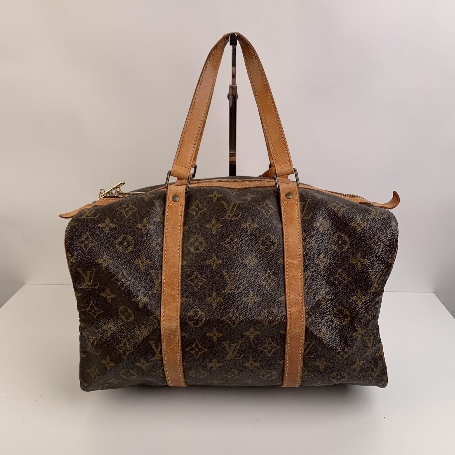 Louis Vuitton classic Monogram Canvas vintage 'Sac Souple' 35. Upper zipper closure. Double leather handles. Brown fabric lining. 'Louis Vuitton Paris - made in France' engraved on leather piece on the side.Removable ID leather tag. Discontinued