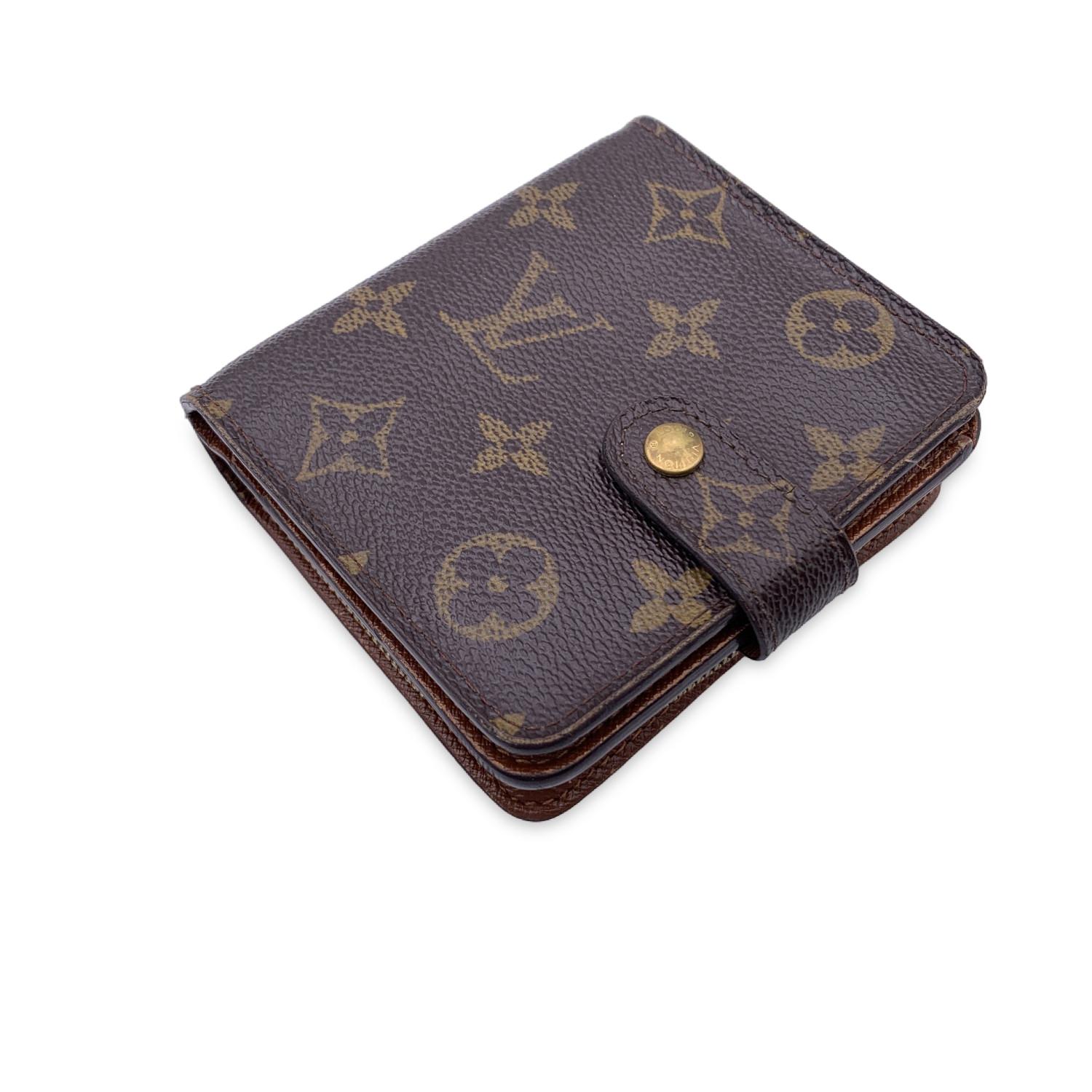 Louis Vuitton vintage square-shaped compact wallet. Snap button. Rear zip coin compartment. Crafted in brown monogram canvas with brown leather interior. 1 bill compartment, 3 credit card slots and 2 open pockets inside. 'Louis Vuitton Paris - Made