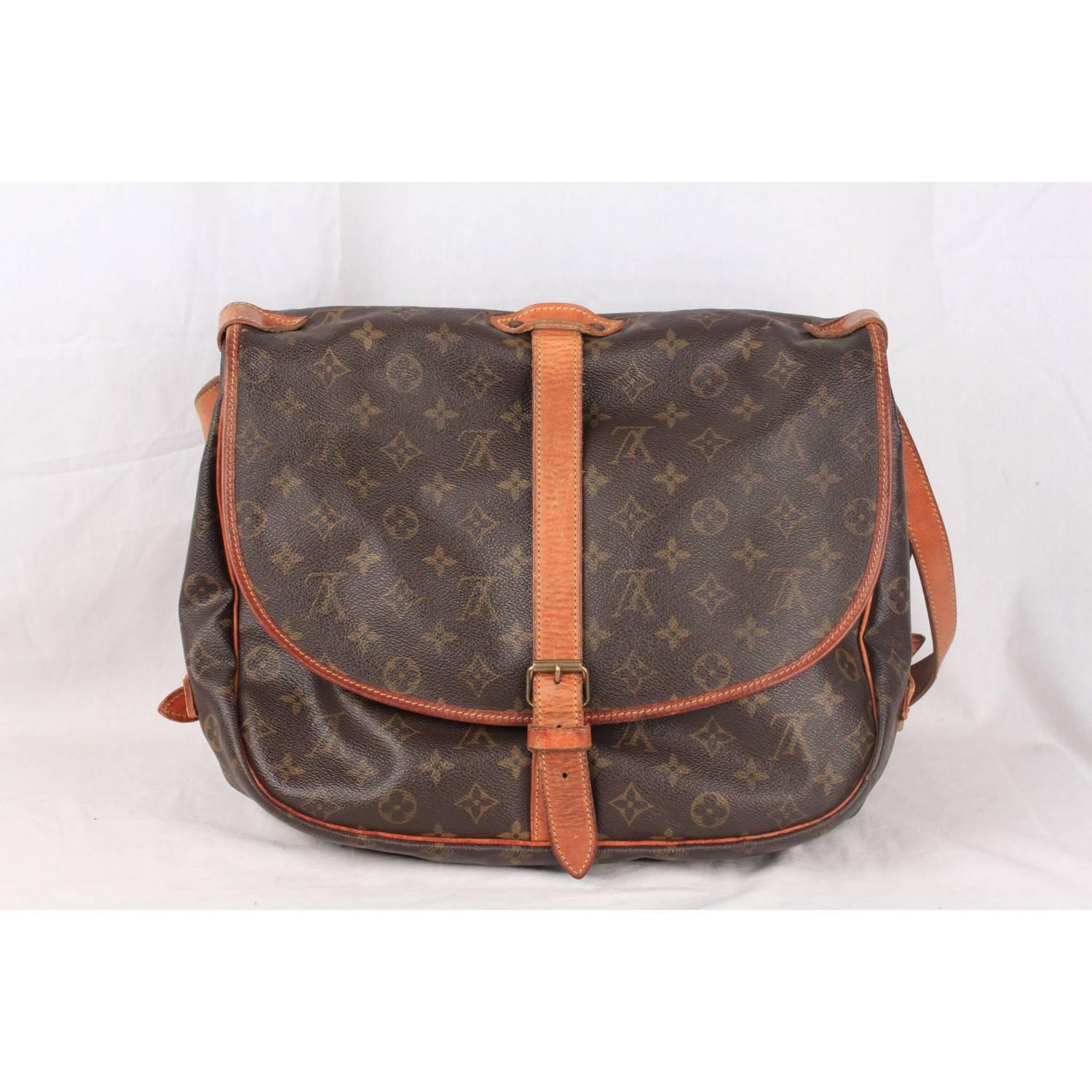 Rare Louis Vuitton Saumur 35 Messenger Bag. Discontinued model, very collectible. Inspired by equestrian 'SADDLE' bag, the legendry SAUMUR 35 features dual front compartments, held tightly together at the sides with belt-like tabs. The extra-large